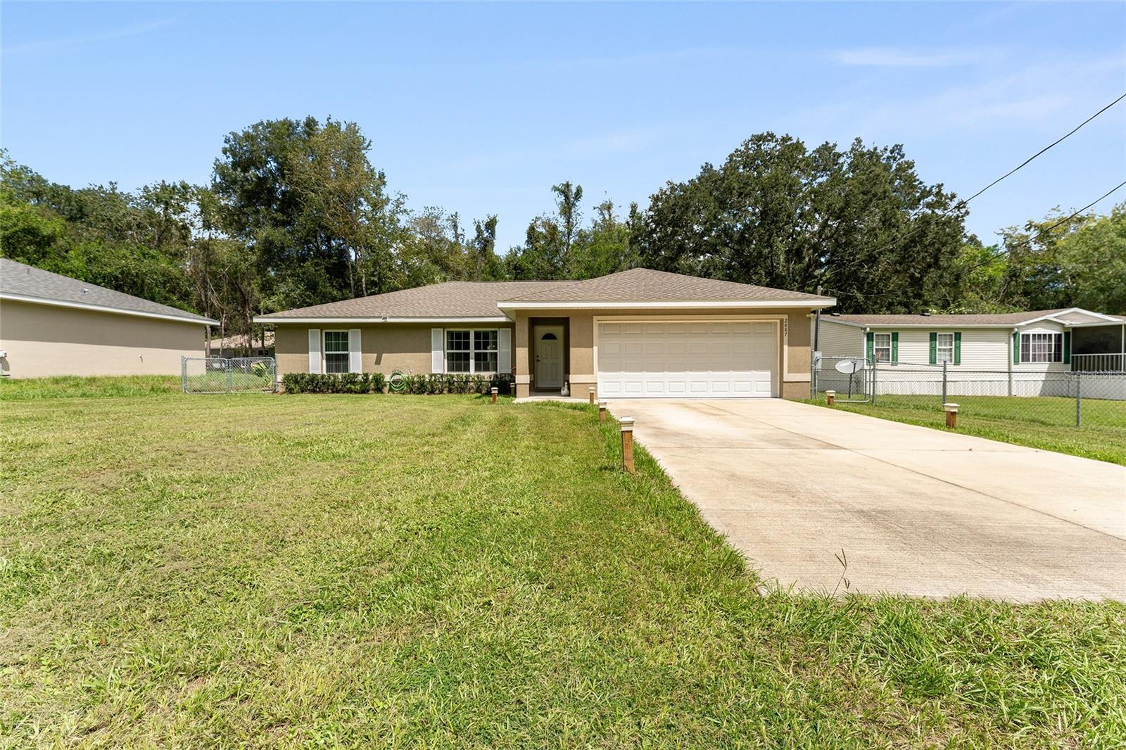 Welcome to this very well maintained Block/stucco home consisting of 3 bedrooms, 2 bath with attached 2 car garage. Beautiful cabinets compliment the gorgeous kitchen. Appliances include Refrigerator, Range with hood and Dishwasher. Walk-in closet in Master. Tile and Carpet floors. High Efficiency windows. Storage shed in fenced back yard only 1 year old. Conveniently located just minutes to The Villages, Belleview and Ocala for all your dining and shopping needs.