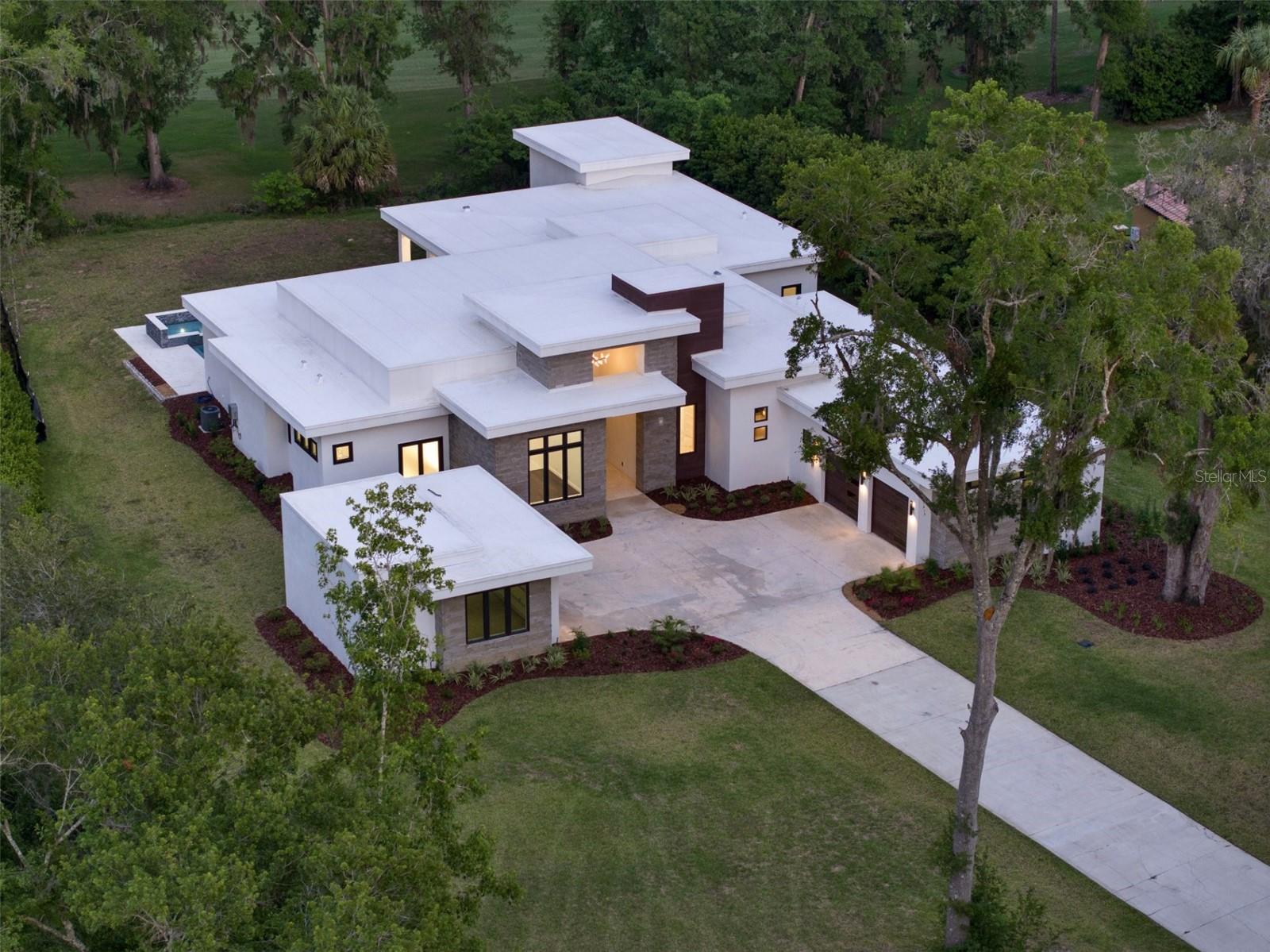 Experience the pinnacle of modern luxury in this stunning new home in the prestigious gated golf course Country Club of Ocala! Built in 2024 and never occupied. This contemporary five-bedroom, 4.5-bath masterpiece combines sleek architectural design with high-end finishes throughout. Other features include a spacious club room for entertaining or relaxing in style, a home gym for your personal wellness routine, and a dedicated office for respite work or quiet study. Enjoy peace of mind with a whole-house Generac generator and a water treatment system. Go outside to a community rich in resort-style amenities, including a championship 18-hole golf course, a sparkling pool, tennis courts and a state-of-the-art fitness area. This home is a blend of elegance, comfort and convenience, ideal for those seeking a vibrant yet tranquil Florida lifestyle.