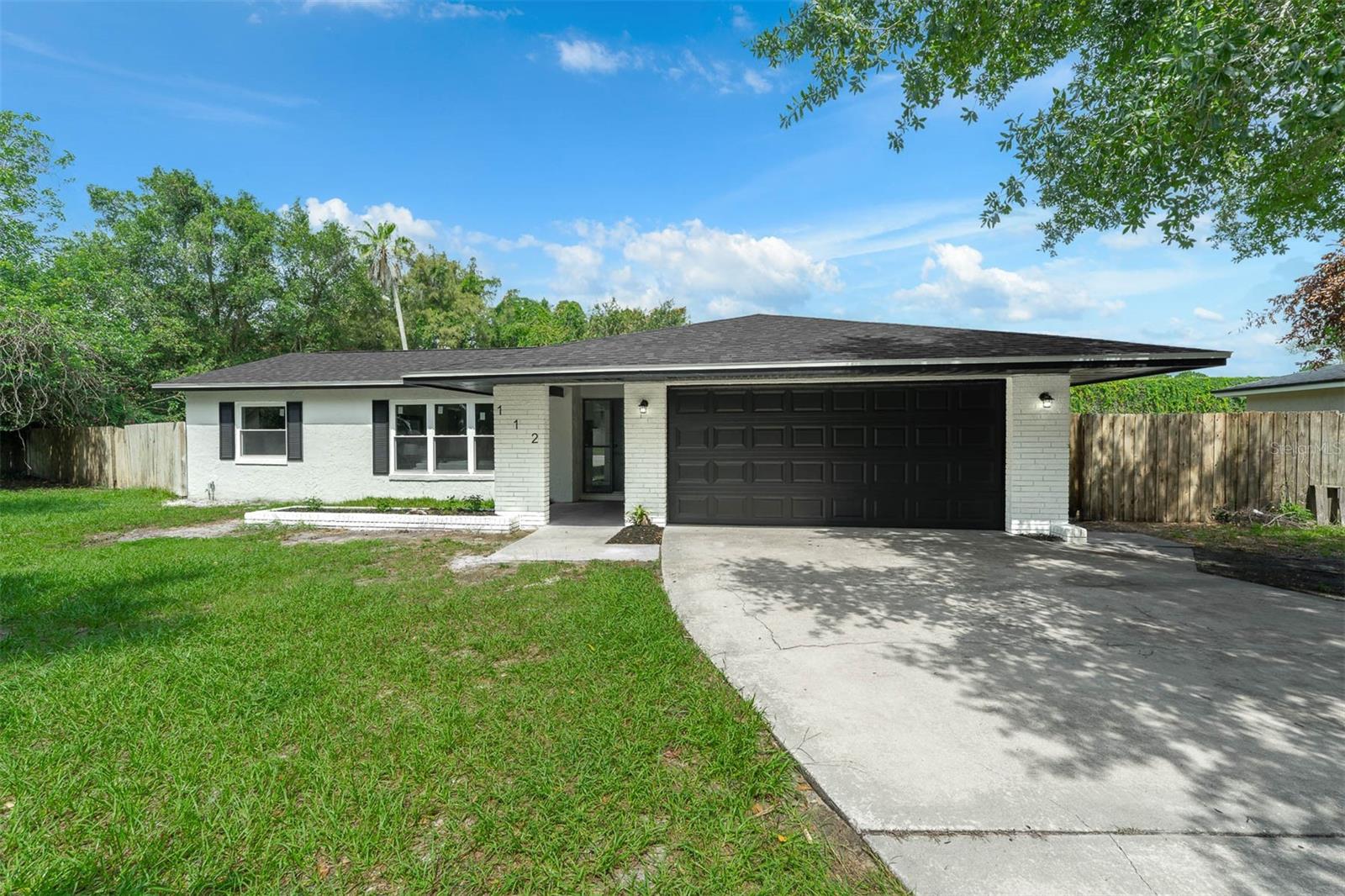Step into this completely renovated Longwood home where every detail has been thoughtfully updated to combine modern style with everyday comfort—all with NO HOA and a massive backyard. From the moment you arrive, the freshly painted exterior, mulch landscaping, and updated flatwork set the tone. Inside, you’re greeted by wide-plank NEW LVP flooring, smooth ceilings , and sleek hardware and lighting fixtures that carry a consistent, elevated feel throughout the home. The heart of the home features a NEW kitchen with 42” white shaker cabinets, granite countertops, gold hardware, and a stainless steel appliance package. It opens seamlessly into the main living area, where NEW recessed lighting and a whitewashed fireplace create a warm, modern atmosphere. Every interior door—including closets—has been replaced, and you’ll find NEW 5 1/4” baseboards and stylish ceiling fans that tie each room together. Both bathrooms have been completely renovated with NEW vanities, granite countertops, custom tilework, and updated fixtures. Large NEW, permitted windows and a sliding glass door flood the space with natural light and lead to your freshly resurfaced private pool and fully cleared backyard—perfect for gatherings or quiet mornings. Electrical has been updated with NEW GFCI outlets in wet area, and modern decora switches throughout. Topped off with a NEW roof, NEW HVAC system, and fresh paint inside and out, this home is truly move-in ready with all major systems upgraded. Located in an established neighborhood close to top schools, parks, and shopping, this is a rare opportunity to own a like-new home with room to live and grow—without the restrictions of an HOA.