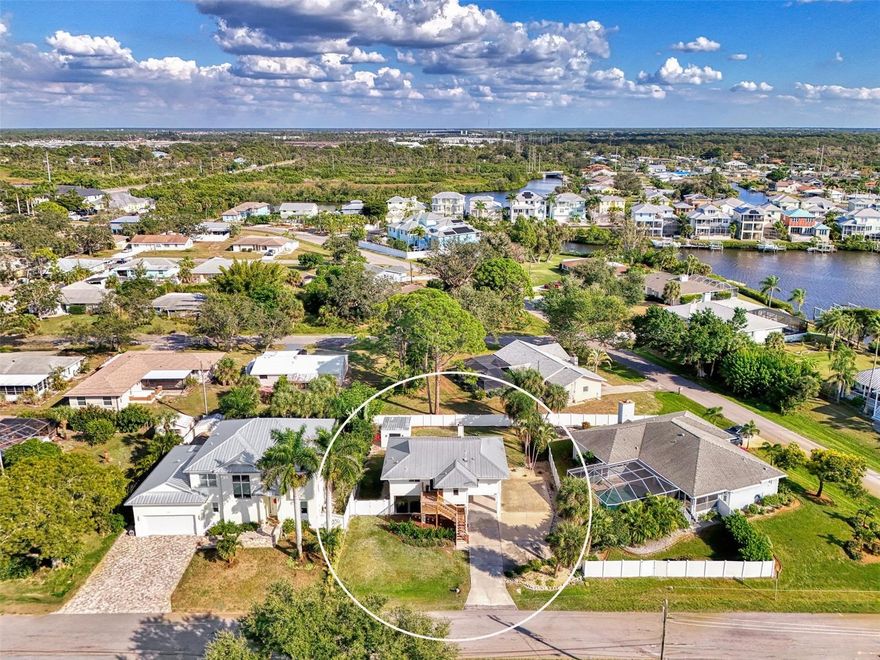 Location, Location, Location!!! Welcome to Hidden Bay Estates. This adorable and affordable home is an advantageous buy surrounded by larger waterfront homes and features WATER ACCESS from the community boat ramp. From the moment you enter you'll feel like you've just stepped into a brand new home with all of the beautiful recent updates! You'll notice the high ceilings, modern designed fireplace and the new flooring flowing consistently throughout. This home offers a split bedroom and open concept floor plan. The kitchen is completely updated with new cabinetry, quartz countertops, and new stainless steel appliances. The primary bedroom features an updated ensuite bathroom and walk-in closet. The guest bathroom is also beautifully updated with modern finishes. NEW WINDOWS AND DOORS (2025). Perfect for living the Florida lifestyle, enjoy access to the expansive balcony from the french doors in the living room or sliding glass doors from the primary bedroom and guest bedroom. You'll truly appreciate the outdoor space with a spacious fenced backyard, expanded driveway (perfect for boat parking), under building parking, and a shed for storage! Plus, plenty of space to add a pool and/or firepit if desired. Best of all is the location with quick and easy access to Tamiami Trail & I-75, within close proximity to the new state-of-the-art Sarasota Memorial Hospital Venice Campus, Legacy Trail, Historic Downtown Venice, beautiful Sarasota County parks, pristine beaches, shopping, restaurants, and so much more! No HOA fee. No CDD fee. Don't wait, schedule a showing today!