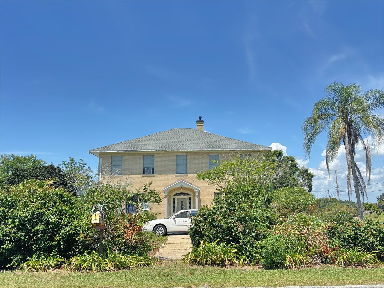 Pool Home with nearly an Acre of land! Welcome to this colonial style home. The home features a 4 bedrooms and 2.5 bathrooms. This unique historical home is situated on the corner of 14th street in Haines City. As you enter the front you are greeted by a foyer and eloquent stair case leading to the upstairs. The down stairs features an expansive dining room complete with chip and dale table (table does not convey but is negotiable). The family room and sunroom are off to the left. The home sits on a .92 acres of land with no HOA and is just minutes from town. This deal will not last, so schedule your tour today.