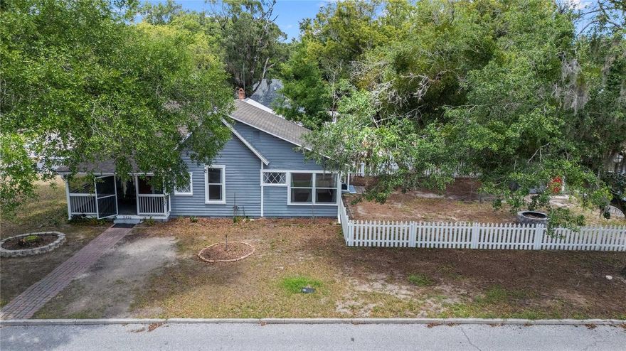 Step back in time while embracing endless possibilities with this beautifully maintained historic home in the heart of Downtown Zephyrhills. Built in 1910 and designated as a protected historic property, this charming 2-bedroom, 1-bath residence offers a rare blend of historic character, modern updates, and mixed-use zoning that opens the door to a variety of residential and commercial opportunities.

A welcoming screened front porch overlooks the tree-lined streets of downtown, creating the perfect place to enjoy your morning coffee or greet visitors. Inside, you'll find bright, inviting living spaces filled with natural light, original architectural charm, and thoughtful updates. The renovated kitchen features modern cabinetry, solid-surface countertops, stainless steel appliances, and ample storage while maintaining the home's timeless appeal. The home also features a water filtration/ softening system installed about 4 years ago.

Situated on a spacious corner lot shaded by mature oak trees, the property includes a detached garage with laundry area, white picket fencing, and plenty of outdoor space. Whether you're looking for a unique primary residence, a live/work opportunity, professional office, boutique retail concept, small café, bed and breakfast, or another creative venture permitted by zoning, this property offers exceptional flexibility in one of Zephyrhills' most recognizable historic districts.

Located within a minute of downtown shops, restaurants, community events, government offices, and local attractions, this is a rare opportunity to own a piece of Zephyrhills history while investing in its future. Historic properties with mixed-use zoning and this level of charm rarely become available.

Schedule your private showing today and discover the possibilities waiting at this one-of-a-kind downtown gem.