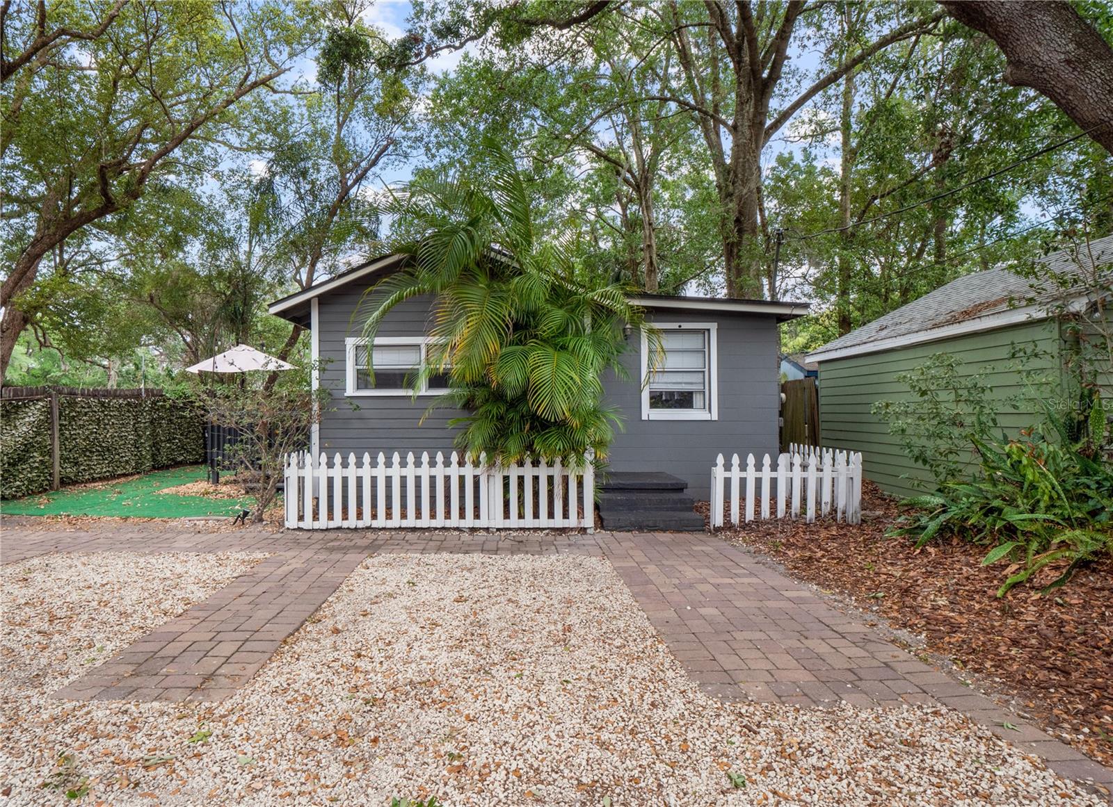 One or more photo(s) has been virtually staged. This stunning home is located near Downtown Orlando, Thornton Park, and Colonial Town. With its own entrance and plenty of privacy, this unit is perfect for individuals seeking a cozy and modern space. Enter into a bright and spacious living room highlighted by a unique A-frame vaulted ceiling that adds character and charm. The suite includes 1 full bedroom, 1 full bath, a fully equipped kitchen with a new refrigerator installed in 2024, and an interior laundry room with a washer and dryer. Enjoy your own private outdoor space, complete with a deck under mature trees, turf lawn, and greenery wall, all perfect for relaxing or entertaining. Key Features & Upgrades include brand new bathroom renovation in 2024, smart locks, Nest thermostat, Ring security system (front doorbell & rear floodlight camera), and a newer washer/dryer! With a 2014 roof, 2018 AC, and brand new 2024 plumbing, you’ll sleep soundly knowing this has been a very well taken care of property. This home offers a blend of historic charm and modern upgrades, ready for you to move in and enjoy.
