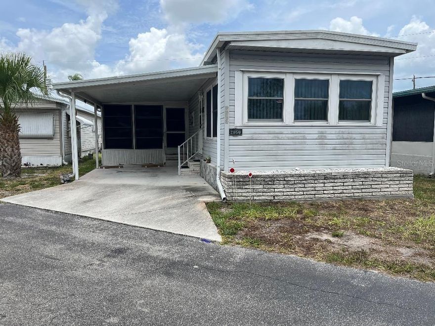 Home is situated in a community near to many attractions. Some in the area are beaches, restaurants, shopping. Home features include laminate floors. Newer membrane roof, PVC plumbing. Washer and dryer are out in the oversized shed with a workshop. Comes furnished. The lanai has a bed for overnight guests. In this Community the home and land come together as Real Peroperty. There is no lot rent. A MUST SEE!