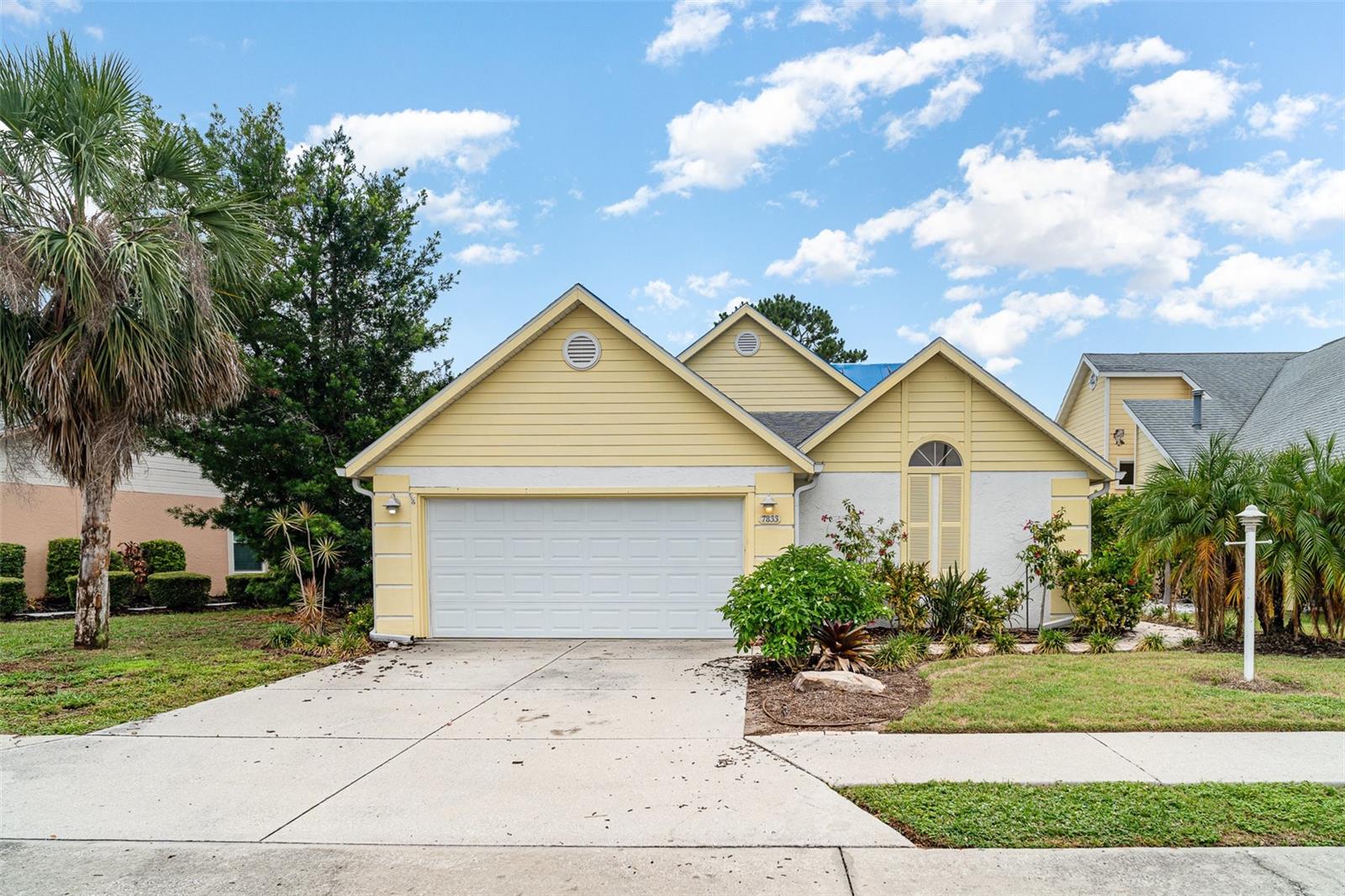 Welcome to this beautifully 2-bedroom, 2-bathroom + den home, perfectly situated on one of the most desirable lakefront lots in the community. Offering energy efficiency, privacy, and neutral colors, this home is just minutes from major highways, world-class beaches, and premier shopping.Home Highlights:Split floor plan with a versatile den—perfect for a home office or guest space,Tile flooring throughout for easy, low-maintenance living,High ceilings enhance the open, airy feel,with plenty of natural light flowing in,Plantation shutters in the living room and second bedroom,Atrium off the dining area adds additional natural light and architectural charm,Screened-in patio and expansive paved outdoor area—ideal for entertaining or enjoying serene lakefront mornings,Rebuilt seawall and tranquil lake views with a beautiful fountain,Fenced backyard for added privacy and peace of mind. Primary Suite Retreat:Spacious en suite with garden tub, walk-in shower, and dual vanities,Walk-in closet offers plenty of storage,Sliding doors provide private access to the screened patio. Energy-Efficient & Exterior Upgrades:Solar system paid in full at closing,New roof to be installed before closing with a transferable warranty,3-year-old hot water heater,Updated front walkway, refreshed landscaping, and modern irrigation system.Don’t miss this opportunity to own a move-in-ready lakefront gem with low utility costs!