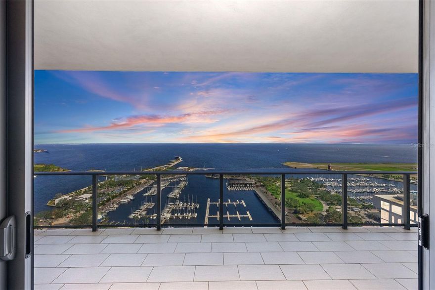 NY Chic Glamour Meets Spectacular Water Views in This Stunning Condo!

Located in the prestigious ONE St. Petersburg building, this extraordinary 2-bedroom, 3-bath condo with a den (that lives like a true 3-bedroom) offers a rare opportunity to own a modern, luxurious residence with breathtaking panoramic views of Tampa Bay, the St. Pete Pier, the iconic Skyway Bridge, and unobstructed city skyline vistas. The highly sought-after floorplan boasts a spacious 40-foot-wide terrace that seamlessly blends indoor and outdoor living, perfect for both entertaining and relaxation. The open-concept living area features soaring 10' ceilings, full-height windows, and sliders that flood the space with natural light, creating an atmosphere of sophistication and elegance.

Reimagined by renowned designer Rob Bowen, this condo underwent a $900,000 transformation, elevating it to unparalleled excellence. Every detail was meticulously considered, from the striking slab marble flooring throughout to the elegant bathroom fixtures and custom-designed wallpaper in the bedrooms and bathrooms. The chef’s kitchen is equipped with top-of-the-line stainless steel appliances, sleek European cabinetry, and a stunning black and gold mosaic tile backsplash. A waterfall kitchen island adds both function and style, while pull-out pantry shelves ensure ease of organization. The custom-designed laundry room includes additional shelving and a wood folding area for added convenience.

Every inch of this condo exudes style and sophistication, from the custom-designed lighting and living room cabinetry with a built-in electric fireplace to the chic ambiance that evokes the glamour of New York City.

The ONE St. Petersburg building offers an exceptional array of amenities, concierge services, an activities director, a formal social room, game room, and club room. The 40,000-square-foot amenities deck features a 75-foot lap pool, cabanas, a spa, lush landscaping, fire pits, abundant seating, and an outdoor kitchen perfect for hosting. A state-of-the-art fitness center and yoga studio further complement the luxurious lifestyle offered at ONE. Located in the vibrant heart of downtown St. Petersburg, ONE is just steps away from over 40 restaurants, upscale shopping, museums, theaters, galleries, and more. Whether you’re in the mood for fine dining, cultural experiences, or leisurely strolls along the waterfront, everything you need is within walking distance.
