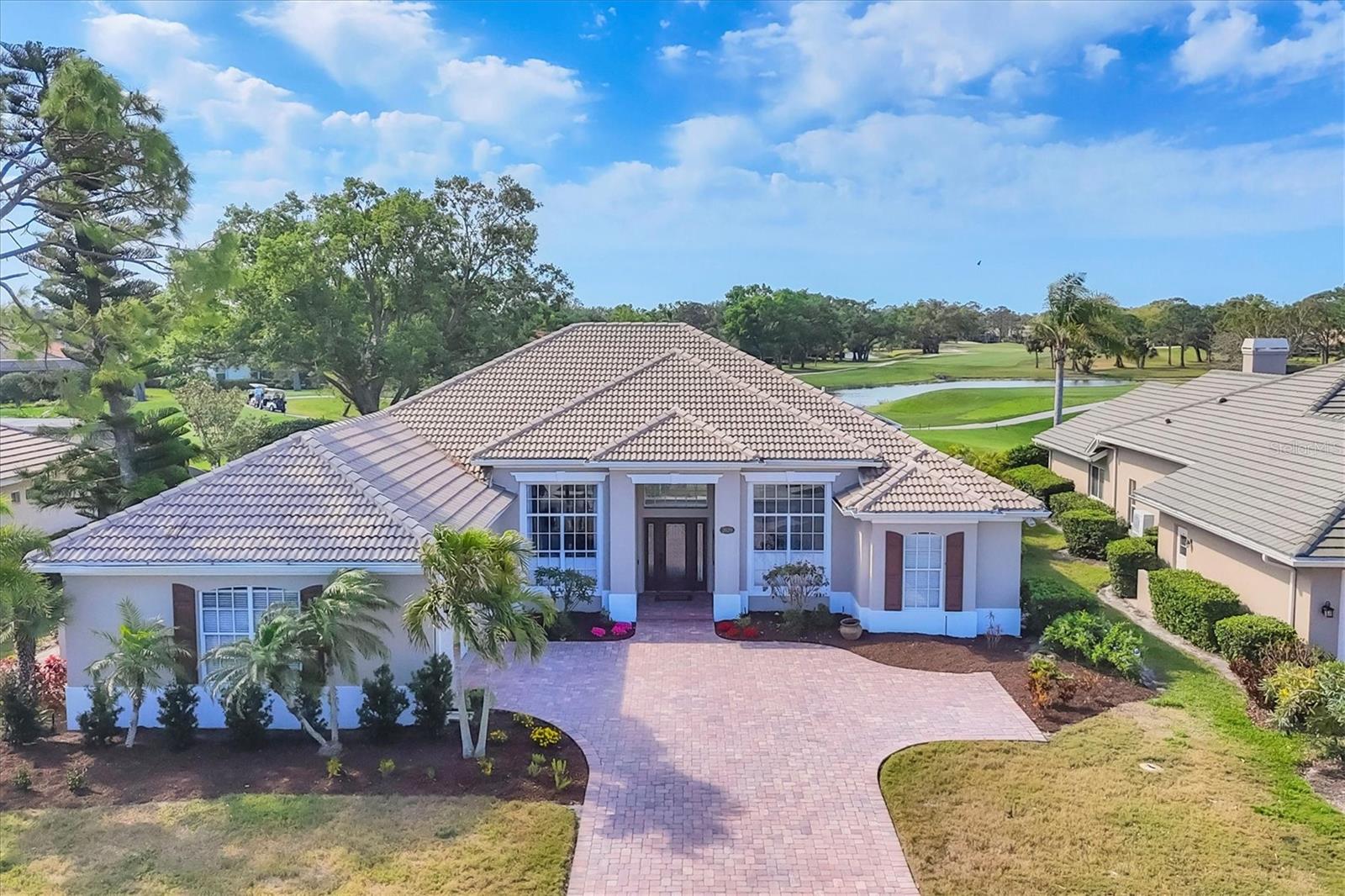 Recent market adjustment. Welcome to this 4 bedroom/ 3 bathroom updated custom home in the much sought after Calusa Lakes community. Beautiful brick pavers set the tone as you pull up to the exterior of the home. Entering the front door you will see the hickory wood flooring that continues throughout the house, 12 foot ceilings that are framed by painted crown molding. Both the spacious Living & Dining Rooms have been recently painted with custom drapes. The sliding glass doors open up and disappear showcasing the large swimming pool and golf course views. The updated kitchen boasts numerous cream glazed wood cabinets, new quartz counters with spaces for 3 counter height bar stools, newer GE Cafe stainless appliances, a side sink/coffee bar. The Family Room is spacious and highlighted by many windows that flood the room with natural lighting. A side door leads out to a small patio that is used for grilling. The bright & airy Primary Bedroom has a tray ceiling as well as sliding glass doors out to the lanai. Two closets complete this relaxing retreat. The spa like updated bathroom has lovely natural wood cabinetry with quartz counter tops. The shower is oversized and is next to a free standing tub & chandelier! The second bedroom in this wing is currently being used as an office and is conveniently across the hall from the pool bathroom. Bedrooms #2 & #3 are in the guest wing off the kitchen and have a door for privacy from the rest of the home. This wing has a full bathroom with a double vanity and walk-in shower. The lanai has brick pavers surrounding the resurfaced heated swimming pool. The southern exposure guarantees afternoon sun for sunbathing, cookouts, and watching the sunset. Great partial lake views along with the 10th green and 11th tee. Membership to the Golf Course is optional. The tennis/pickleball courts are open to all residents as well as the restaurant located in the Golf Pro Shop. This community is close to the Legacy Trail, shopping, Venice Island, I #75, airports, both Nokomis Beach & Venice beach, public boat ramps and marinas. Run don't walk to see this move-in ready home perfect for full time or seasonal owners. Paradise awaits!