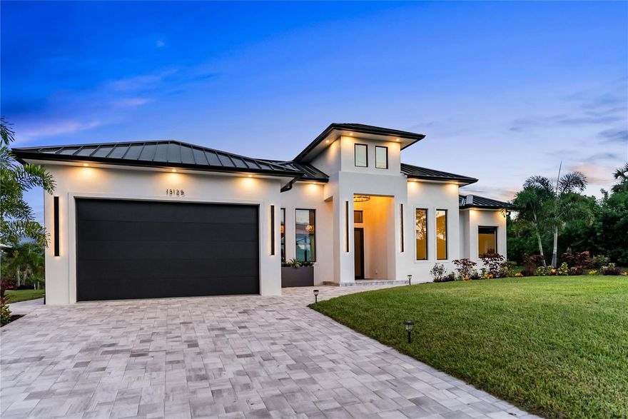 This Gulf Access waterfront estate offers 3 bedrooms, 3 bathrooms, an office, pool, spa, and high-end finishes throughout. With direct boating access to the Myakka River and the Gulf—and no fixed bridges except one with ~24ft clearance—this home is a boater’s dream and an entertainer’s delight.

The exterior is fully landscaped with an irrigation system and lush St. Augustine lawn, complemented by a concrete seawall along the canal. A high-quality standing seam metal roof, PGT impact-rated insulated windows and sliders, 10ft impact sliding doors, 9ft impact garage doors, an 8ft impact front entry door, and 8ft interior doors throughout provide strength, beauty, and durability. Added insulation in the home and roof enhances comfort and energy efficiency, while a 16 SEER high-efficiency AC system delivers reliable climate control with lower energy use. A whole-house reverse osmosis water treatment system supplies premium quality water from a rare deep artesian well, an exceptional feature that adds long-term value and reliability.

Inside, soaring ceilings—14.4 ft in the living and dining rooms and 11.4 ft in bedrooms and baths—create an open, airy atmosphere enhanced by oversized picture windows that capture breathtaking water views. Flooring is thoughtfully appointed with tile in bathrooms and laundry, marble in showers, and premium waterproof engineered wood throughout the main living areas. All closets are custom built with shelving and drawers, while the garage features commercial-grade epoxy flooring.

The gourmet kitchen showcases a stunning quartzite island, countertops, and backsplash, along with quartzite counters in the pantry, premium KitchenAid appliances, and designer lighting, including Restoration Hardware chandeliers and Arhaus pendants.

Step outside to the expansive patio and lanai, where a built-in outdoor kitchen and panorama screen enclosure set the stage for entertaining and relaxation. The heated pool is equipped with top-of-the-line Jandy equipment, offering superior performance and reliability. This oversized outdoor space is perfect for large gatherings or private enjoyment of spectacular sunsets. Watch dolphins, manatees, and other marine life glide by from your backyard paradise.