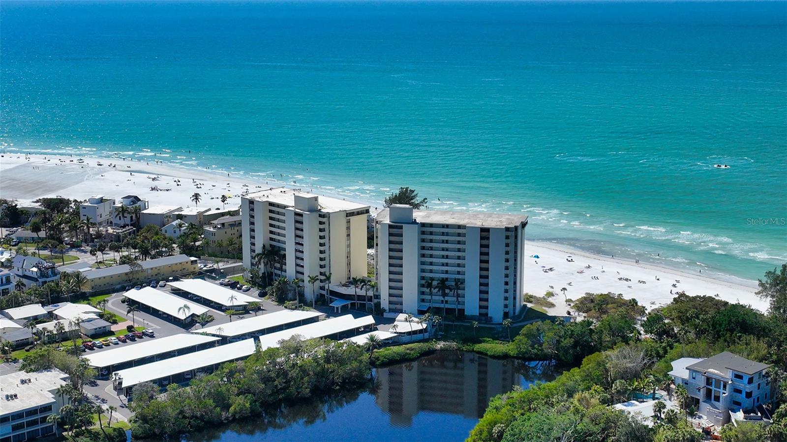 Located on arguably the finest beach on the planet, Whispering Sands offers the best of what the Siesta Beach lifestyle has to offer. After a serene day lounging on the 800 feet of private beach seemingly miles away from the worries of the world, you can relax on your patio hearing nothing but the soothing sound of azure waves gently lapping the pristine white sand shoreline, as you watch the sun slowly sink below the horizon of the Gulf of Mexico. After such a relaxing and rejuvenating day, perhaps you step out for an evening of fine dining and entertainment at any one of the excellent restaurants situated in the world-renowned Siesta Village. Or take a short drive to visit downtown Sarasota and enjoy the vibrant arts and entertainment scene there which includes, theater, opera or stage productions at the Van Wesel. At the end of your day, you will be lulled to sleep while listening to the soft rhythms of the ebb and flow of the gulf waters, accompanied by a warm tropical sea breeze. You awake the next day, thinking it was all a wonderous dream only to realize that you are truly living in paradise. Whispering Sands is a 55+ community that offers beautifully landscaped grounds and a wide variety of activities in addition to beach living, including two heated swimming pools, shuffleboard, kayak/canoe storage, along with rustic tiki huts and charcoal grills perched next to the beach perfect for a sunset cookout. There’s also a natural lagoon and a clubhouse that includes Wi-Fi and a fitness center and 24-hour security. This second floor 2-bedroom 2 bath unit is on the same floor as the private large library/gathering space with a separate kitchen, television and table tennis/pool table making larger get-togethers and entertaining for family and friends a breeze. The unit features tile flooring throughout (perfect for the beach lifestyle) and is ready for immediate enjoyment by the next owner. Understandably, you may wish to personalize and update some features of this perfectly situated unit in which case, there is a full set of planned updates along with cost estimates from qualified vendors available for review.