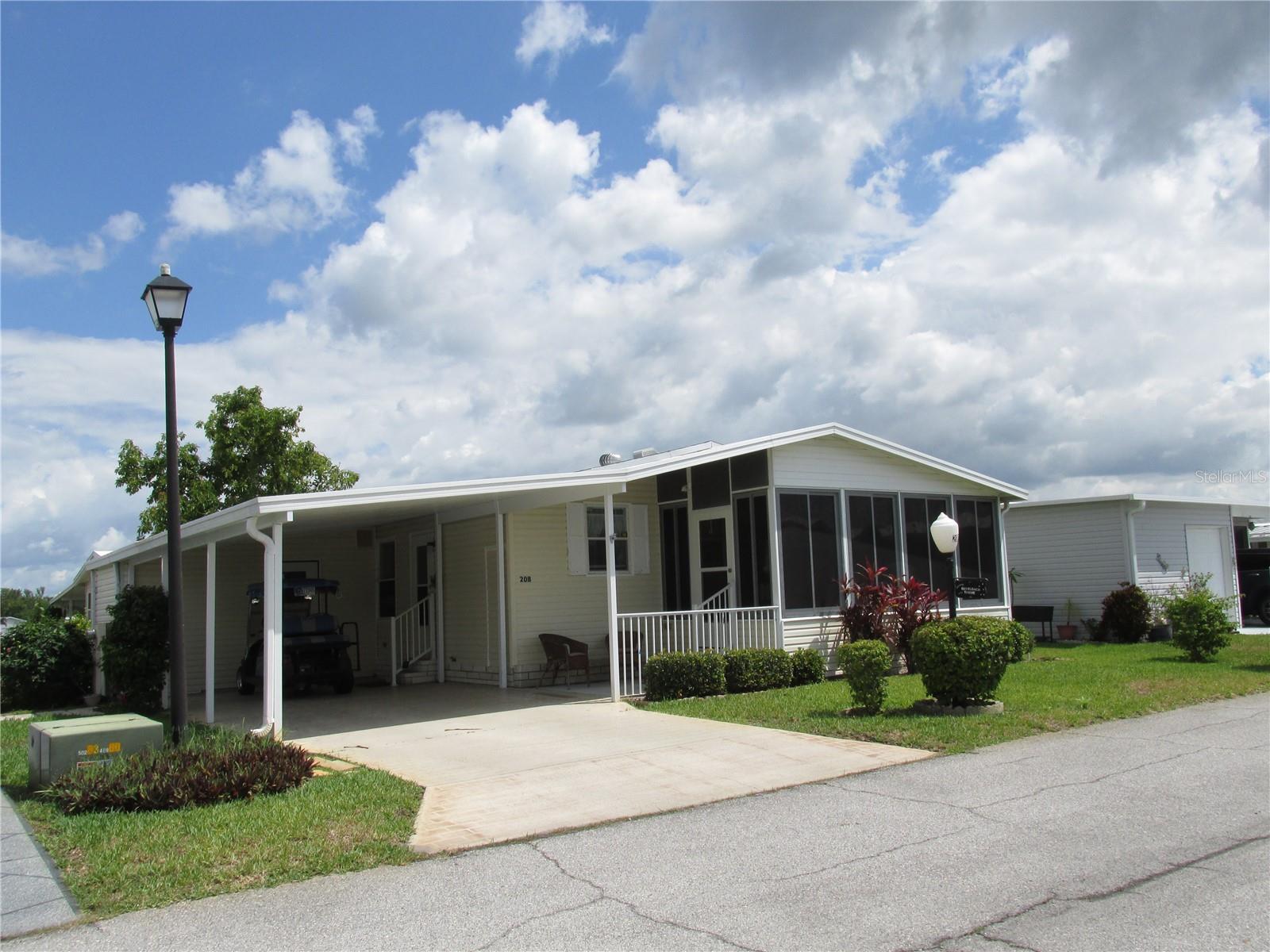 1990 small but roomy home in highly active 55plus community. 2 bedrooms, 2 bath home furnished, available for immediate occupancy. New roof and new A/C unit and no gray pipe plumbing. Kitchen updated with newly painted cabinets and counter tops with added breakfast bar for additional prep space. Nice lanai on the front facing street, with new acrylic windows. Many amenities throughout the community to keep you busy whether it is card playing, golfing, swimming, dancing, exercising or a short stroll to the lake. Even a golf cart ride is available on the included golf cart.