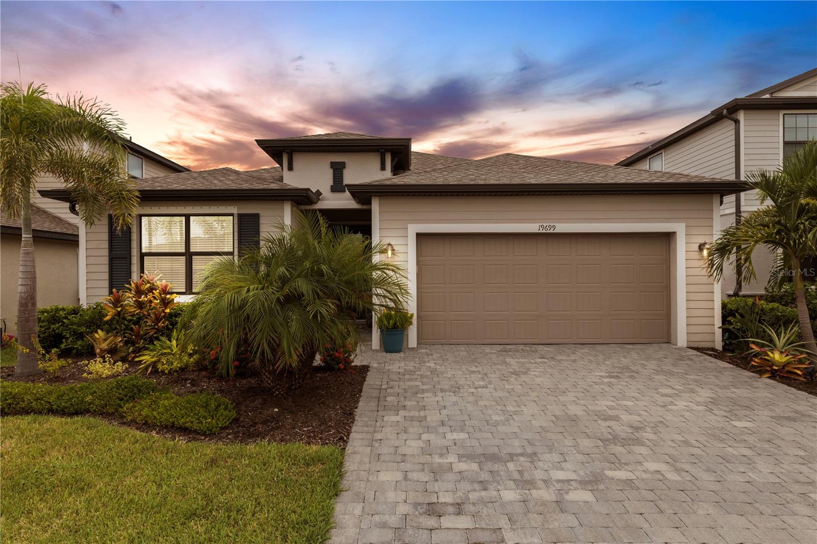 Exquisite Marsala Model with Designer Finishes & Private Resort-Style Pool and Spa with Preserve Views in Wellen Park!
Welcome to this beautifully designed 3-bedroom, 3-bathroom home with a versatile den/flex room, located in one of Wellen Park’s most sought-after, golf cart, family-friendly communities and maintenance free! The extended driveway allows for plenty of parking. Step into the grand foyer with custom wall detailing, soaring ceilings throughout, and an abundance of natural light that sets the tone for sophistication. The CHEFS GOURMET KITCHEN features white shaker cabinetry with top moulding and designed with convenient pullout drawers for pots and pans and trash bin.
CUSTOM CALACATTA QUARTZ WATERFALL COUNTERTOPS AND BACKSPLASH, an abundance of cabinets and counters for the entertainers dream, EXTENDED CENTER ISLAND, stainless steel appliances, and a spacious WALK-IN pantry—perfect for culinary enthusiasts. The open layout seamlessly flows into the dining and living areas, opening through 8’ TRIPLE SLIDERS to the expansive lanai with serene preserve views, creating the perfect backdrop for breathtaking sunset evenings over the preserve and birdlife.
The luxurious primary suite offers a serene retreat with TWO walk-in closets, a spa-inspired bath with soaking tub, dual sinks with granite countertops, and a tremendous large glass-enclosed shower. The junior en suite is ideal for guests or in-laws, featuring its own private bathroom with a walk-in shower. A third bedroom with a nearby full bath provides comfort and convenience for family or visitors.
Enjoy the spacious den/flex room with French doors, a well-appointed laundry room with utility sink and cabinetry, this home offers peace of mind with a touch of luxury in a X FLOOD ZONE (LOMA Certificate). The lanai includes outdoor lighting, paver decking, and a CUSTOM BRAND NEW ELECTRIC KEVLAR HURRICANE SCREEN SYSTEM for added protection, while the CUSTOM SALTWATER HEATED, PEBBLE TEC, SPILLOVER SPA WITH SUN-SHELF INCLUDES GLASS MOSAIC TILE transform the backyard into a PRIVATE OASIS ideal for entertaining or relaxation on one of the most secluded and peaceful lots in the community. HOA fee includes lawn mowing, mulching, trimming, fertilizing, cable and internet, irrigation and gated entry. Located just a golf cart or walking distance from Costco, Downtown Wellen Park, CoolToday Baseball Park, restaurants, shopping, and more—there’s always something to do! From farmers markets, baseball games, fireworks, special events, walking groups, yoga, zumba, cycling groups, and endless recreation—this is the lifestyle you’ve been waiting for!