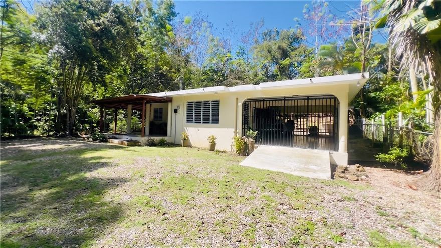 Tucked into the greenery of Bo. Calvache, this private 2-bedroom, 2.5-bath home offers a comfortable, practical layout and convenient location. Sitting on an 822 m² lot, the property is surrounded by mature trees and natural landscaping. A large covered outdoor area adds flexible space for lounging, hobbies, pets, or use as a sheltered carport. The home also includes a spacious laundry and storage area and lovely private yard. With quick access to Carr. 115, you’re only a short drive from Rincón’s beaches, surf spots, restaurants, and daily conveniences. Pets are welcome with no fees or size restrictions.