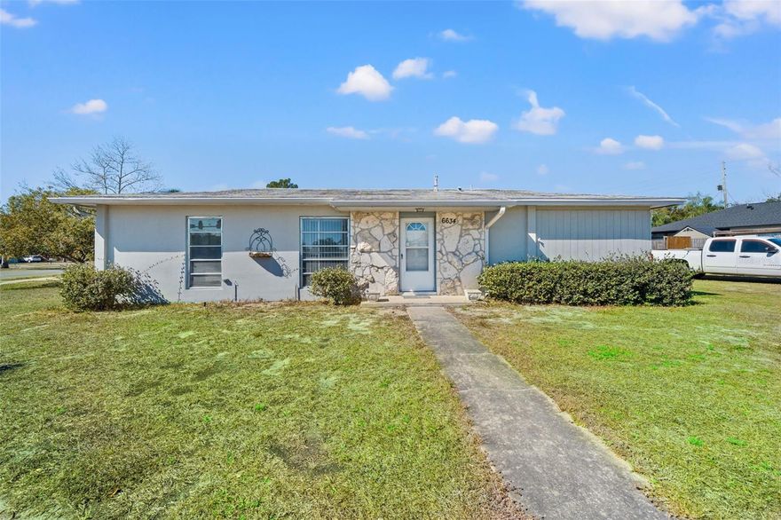 Centrally located, large corner lot featuring 3 bedroom, one bath home offering a great opportunity for a starter residence or investment property. This home retains its original character, providing room for cosmetic updates. Major system improvements have already been completed, including a new HVAC (2023) and updated electric (2024) with 200-AMP service. A propane tank supplies the gas stove and hot water heater. SELLER AGREES TO REPLACE THE ROOF prior to closing with an acceptable full-price offer, subject to executed contract terms.
In addition, the third bedroom features a separate exterior entrance, offering flexibility for a private guest suite, or Mother-In-Law style setup, or FLEX SPACE. This home also features an enclosed, temperature controlled rear sunroom - adding additional usable space beyond the main living area. The outdoor space includes a large covered patio perfect for entertaining and enjoying the outdoors. The property also includes TWO UTILITY SHEDS ideal for hobbies such as woodworking or automotive projects , along with a concrete slab extension and roof overlay for covered equipment or recreational toy parking areas; with 120 - 220 AMP electrical service. Centrally located in Spring Hill near plenty of restaurants, supermarkets, parks and recreation. This home sits approximately 15 minutes to the beach and close proximity to 3 local hospitals and about 45 minutes to Tampa International Airport - An excellent opportunity for buyers seeking a centrally located home with upscale potential and flexible living space.