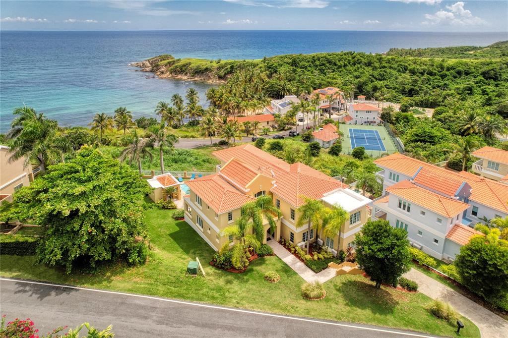 Boasting an exceptionally privileged location on the scenic hillside of Palmas del Mar, this Mediterranean Contemporary residence is the epitome of tropical elegance. Completely renovated in 2018, this immaculate property offers plenty of natural light, double height ceilings, and an unrivaled view of the ocean.
Spanning three floors, the expansive layout includes 6 bedrooms, 6 full baths and two partial. Striking details such as a glass wall with Eastern exposure at the foyer and a harmonious and inviting Coastal Design enhance the 4674 sq ft interior.
An open floor plan and a chef grade kitchen including double built in ovens and a 5 burner gas cooktop thoughtfully set on an ocean facing center island, provide the perfect setting for family gatherings and entertainment.The main level features the dining-room, living room and family room, complete with a wet bar. The lower level includes a wonderfully staged media room and an adjacent guest bedroom and bath. Multiple walk-in closets, balconies and a spacious laundry room complete the well thought-out layout.
The impressive property is highlighted by an ample outdoor space which showcases a pool, spa and covered wet bar with BBQ and a half bath. Golf-cart parking, full power generator and hurricane resistant windows are graciously provided. 53 Shell Castle grants potential owners a greatly coveted Caribbean lifestyle in a warm and relaxed atmosphere.
Offering the ultimate levels of comfort and convenience, Palmas del Mar is internationally renowned for its top golf courses, tennis courts, equestrian center, private school, restaurants, shopping venues and beachfront location on the southeast coast of the island. Only a 40-minute drive away from San Juan, enjoy the pinnacle of resort living while still being in close proximity to the Metropolitan area.
Annual Hazard Insurance: $3,264.
Annual HOA Fee: $900.
