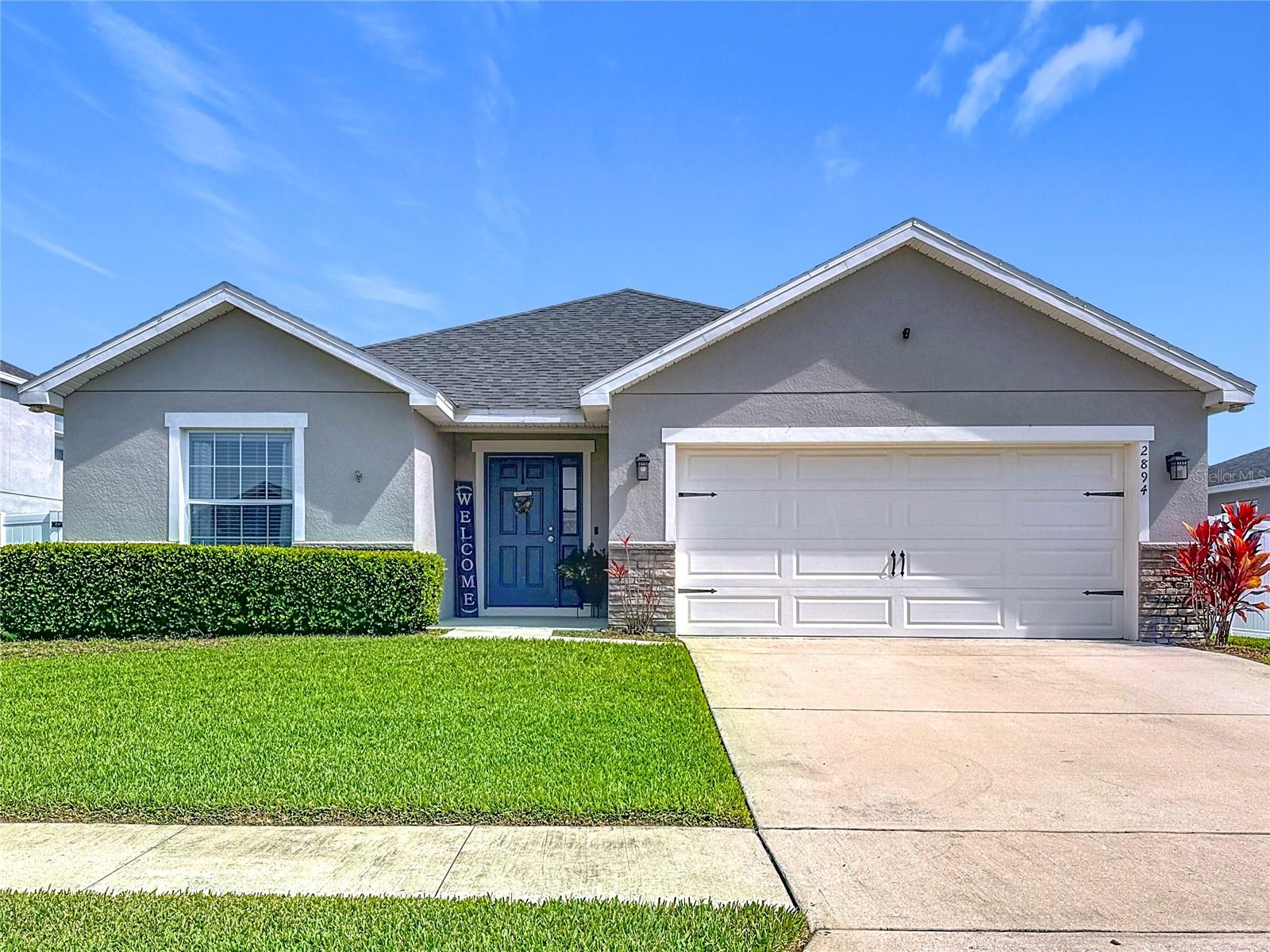 Welcome to this beautiful 4 Bedroom 2 bath home which has been meticulously maintained in the Gramercy Farms Community. As you arrive, you're welcomed by the professionally maintained green grass and completely fenced yard. You will be impressed with the open floor plan with a spacious gathering room, dining area, and an open kitchen with counter-height Island and an oversized walk-in pantry. The kitchen comes with large cabinets with crown molding and fully equipped with stainless steel appliances! Volume ceilings throughout the living area, dedicated laundry room. The owner's suite features an elegant tray ceiling, and an upgraded en-suite bathroom with garden tub, dual sinks, and a walk-in closet. The screened in rear patio is great to unwind and enjoy the Florida weather or watch your favorite sport which includes TV hookup and fan already installed for your convenience. This home also features a built-in pest control system. The spacious two car garage has a side door making it convenient to access the exterior of the home. It does not end there; the laundry room comes equipped with front load washer and dryer! Within a short walk this beautiful, landscaped community offers a playground, dog park, and a basketball court, for entertainment. Easy access to the FL Turnpike which provides a convenient way to visit the Central Florida attractions including Disney World, Universal Orlando, and many more! Located nearby premier shopping, grocery stores, and many restaurants. Also, top rated schools. Come see it today!