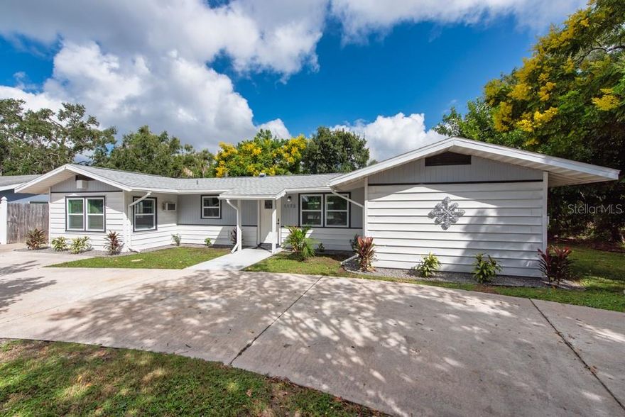 **PRICE IMPROVEMENT** Have peace of mind with an X-rated flood zone, no history of water damage, and all-new impact-resistant, hurricane-rated windows. Sun-filled living and income potential come together beautifully in this centrally located Sarasota home!

This updated property offers a 3-bedroom, 2-bath layout featuring a private primary suite complete with a luxurious new bathroom and kitchenette — providing a resort getaway feel right at home. With its own separate entrance, this flexible space also doubles as a fantastic in-law suite. The home offers great income potential if the suite is used as a separate 1-bedroom, 1-bath studio, ideal for high-demand rentals. Together, the spaces provide 1,361 square feet of refreshed living area.

Step inside to discover new flooring throughout, a modern kitchen and updated bath, and stylish new lighting that enhances the home’s bright, open feel — all beautifully upgraded with new appliances, AC, water heater, and roof for lasting comfort and value.

This property also boasts a generous yard — perfect for those who crave extra outdoor space. Whether you envision a private garden, a play area, or a space for the family pets, this oversized side yard offers endless possibilities. Mature landscaping provides both beauty and privacy, creating a peaceful setting for outdoor relaxation.

The outdoor area is made for Florida living — dive into vacation-style living with an expansive, oversized pool — perfect for lap swimming, entertaining, and making lasting memories. A huge screened lanai invites relaxation and provides plenty of space to host poolside gatherings and parties. A mini golf green adds a playful touch for family and friends.

Whether you’re looking for a home with extra income potential or a flexible multi-use property, this one checks all the boxes.

Conveniently located near downtown Sarasota, St. Armands Circle, Siesta Key Beach, the Sarasota-Bradenton Airport, and the UTC shopping district, you’ll be right in the heart of everything the Gulf Coast has to offer.

A rare opportunity to enjoy a move-in-ready home and an income-producing asset — all in one desirable Sarasota location!
**Free 1/0 Interest Rate Buy Down available when using our preferred lender.**