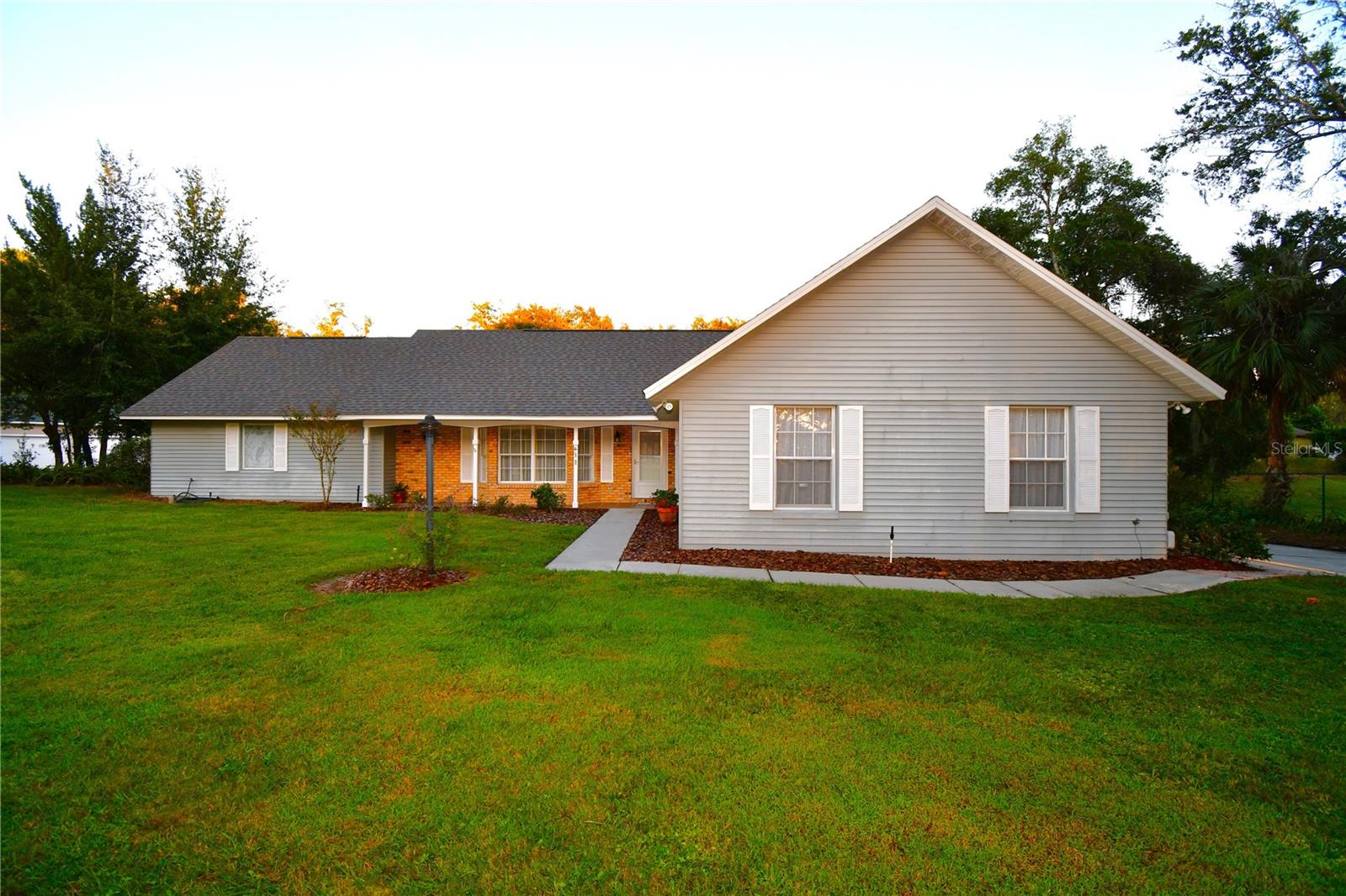 Charming Lake Gertrude Retreat with Pool
Welcome to 611 Old Eustis Road—an inviting 3-bedroom, 2-bath, 2-car garage, pool home nestled on an oversized lot with with Dogwood Mountain community dock and lake access to the sparkling waters of Lake Gertrude. This property blends natural beauty, thoughtful design, and seller owned solar panels that provide energy efficiency for the perfect Florida lifestyle with a monthly utility bill of only $35. Interior highlights include a spacious eat-in kitchen, open-concept dining and living area with vaulted ceilings, exposed wood beams, and a cozy wood-burning fireplace. The Master suite featuring an oversized walk-in shower, dual sinks, and a generous walk-in closet. French doors from the master bedroom, great room, kitchen, and third bedroom open directly to the pool deck—ideal for indoor-outdoor living
Outdoors you’ll enjoy a screened private pool area and large deck surrounded by lush landscaping on an oversized lot. Private Lake Gertrude access is located across the street. Enjoy kayaking, paddleboarding, or peaceful sunset views. Schedule your private tour today and experience the charm of lakeside living in Mount Dora.