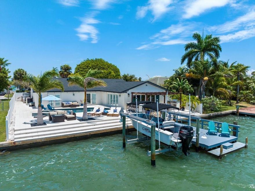 ASSUMABLE LOAN AT 3.4%!!!!!!!!!!!!!!!!!!!!!!!!!!!!!!!! A Dream Come True.... Welcome to your perfect waterfront Oasis in a resort-style
backyard with newly renovated chill lounging areas and a saltwater pool/spa. Your private dock and boat lift are steps away, so you can enjoy endless sunsets, dolphin play, manatees, and countless other island experiences—an absolute dream come true. Step inside to discover a comfortable sanctuary. The heart of the home is the kitchen, updated in 2023 with new granite countertops, a waterfall island that seats 6, and all - new stainless-steel appliances. This modern yet inviting space is perfect for both casual family meals and entertaining guests. The oversized living room features tray ceilings and a wall of sliding doors to allow nature inside!! With no carpet throughout, cleaning is easy, and the modern tile floors add warmth to the space. The bathrooms, updated in 2024, offer a touch of luxury, while the four spacious bedrooms provide plenty of space for everyone to unwind. Executive touches like custom plantation blinds, beautiful barn doors, and custom huge master walk-in closets add an elite status to this amazing property. A key feature of this property is the mother-in-law suite with a modern kitchenette, its own entrance, and a driveway for parking. The flow of this all-one-level home, with patio doors
across the entire backyard, makes it an entertainment dream for friends and family. Outside, the large, covered patio is ideal for enjoying the outdoors, rain or shine. Enjoy your morning coffee or tea in your beautiful, enclosed courtyard with new French Doors that open from the kitchen. These indoor /outdoor transition spaces make this already large well-appointed home feel even more spacious. We could not complete the description of this world-class property without showcasing St Pete Beach's #1-rated white powder beaches and intercoastal waterways. Ranked as a top beach destination GLOBALLY, this home is in the heart of the island, just blocks from the beaches, excellent bars, and restaurants. Come relax, embrace, and enjoy the good life! ASSUMABLE LOAN IS FOR $735,000 AT 3.4%. - SELLER WILL ALSO ENTERTAIN OWNER FINANCE WITH 1.5M DOWN - 2.5% POINTS - 10% INTEREST - 3-5 YEAR BALLOON. BRING ALL OFFERS TODAY!!!