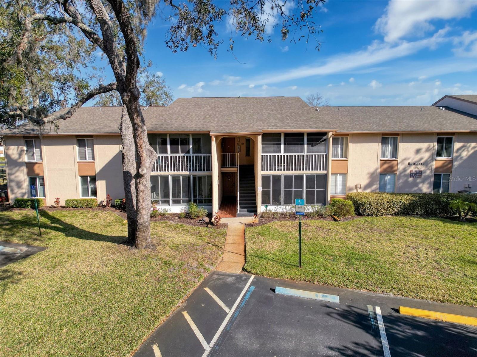 Welcome to the gated community of Pine Ridge at Sugar Creek located off SR52 in Hudson. This 2nd floor 2-bedroom/2-bathroom condo is looking for a new owner. The condo has been well maintained and move-in ready. The layout consists of a large living room with a small dining area next to the kitchen pass through. There is a comfortable eat in space in the kitchen. At the front of the living room there is a screened in Balcony whereby you could enjoy a morning coffee, etc. at the back of the living room there is a hallway that provides access to the laundry room guest bath and bot the primary and 2 bedrooms. Pine Ridge is centrally located near the Suncoast Parkway making it easy to get to Tampa Internatinal Airport, Downtown Tampa, etc. To the north there is SunWest Mine County Park, Weeki Wachee and Homosassa Springs which offers a slice of Old Florida to enjoy crystal clear waters for kayaking and manatee sightings. The community has a clubhouse, pool, tennis and shuffleboard courts for resident to enjoy.