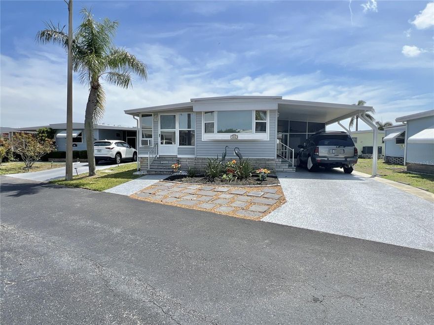 Home sweet home! Well-maintained 2 bed/1.5 bath home with 958 sq. ft of living space which includes an air conditioned Florida room that could be a hobby room/den or extra sleep space. The upgrades are many: 2021 Central AC system with 2024 ductwork; beautiful wide-plank laminate flooring with 2024 vapor barrier underneath to protect the subflooring; spacious kitchen with 2022 stainless appliances, corian solid surface countertops and lots of cabinets for storage; inside washer and dryer for ease of use; and 2011 roofover making a double roof! Adding to the living space is the 324 sq ft screened lanai to enjoy the outdoors. 2-car carport with extended driveway and side kickout to make parking easy. The location is excellent as the home is a short walk to the community waterfront park--enjoy waterfront living without the high price! Price includes share for the lot and ownership in the co-op. Two Pets (dogs or cats) up to 35 pds each are welcomed! Renting is allowed with 2 month minimum. Management requires a 675+ credit score for buyers. Popular Americana Cove is located only 10 mins from downtown St. Petersburg, 15 mins to two airports and 3 mins to 4th Street dining, shopping and medical. This is truly a 55+ retirement community and home to enjoy!