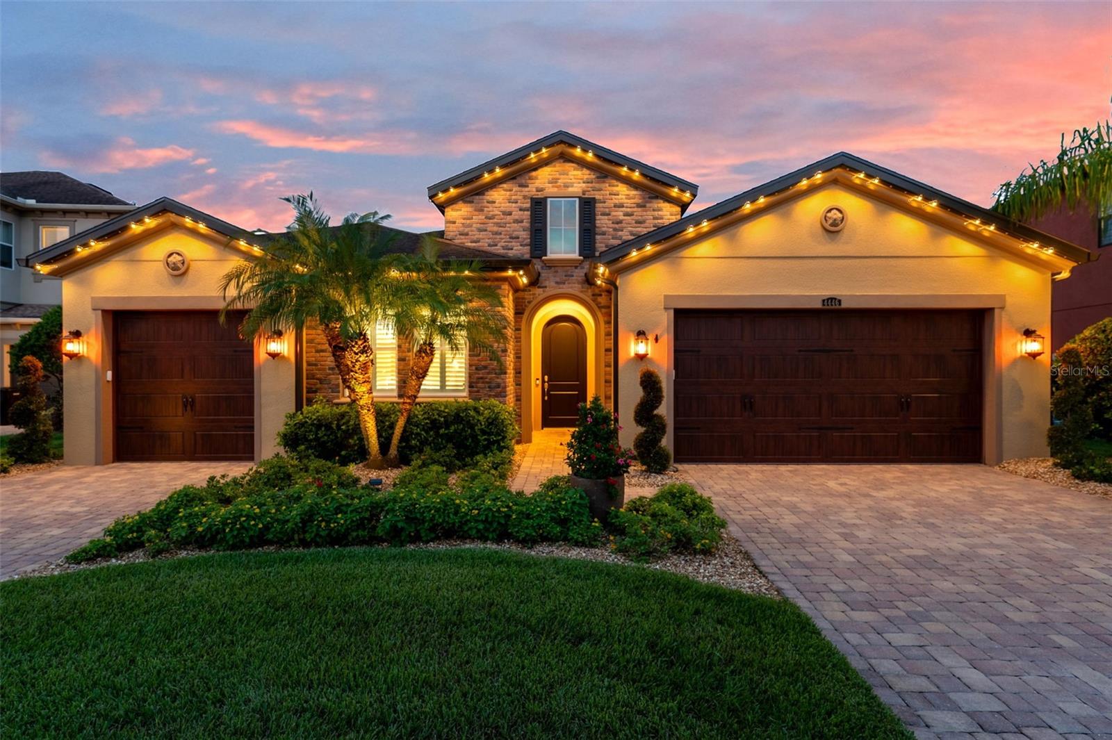From the moment you step through the doors of this Hamilton floor plan, your eye is immediately drawn across the foyer to sweeping water & conservation views that set the tone for a home defined by elegance & effortless Florida living. Perfectly situated at the end of a cul-de-sac, its timeless curb appeal is evident in the brick-paved driveway, manicured landscaping, custom exterior & nebula lighting, & a freshly painted exterior that glows with sophistication. Offering 2,584 sq. ft. under air & 3,720 total sq. ft., the residence unfolds with engineered hardwood flooring throughout, crown molding, custom ceiling fans, plantation shutters, new window coverings & refined architectural details. At the heart of the home, the gourmet kitchen commands attention with an oversized island & breakfast bar, custom wood chimney hood, natural gas cooktop, double wall ovens, built-in microwave, full extension cabinetry with glass inlays & a walk-in pantry, flowing seamlessly into the formal dining room, sunlit dinette & expansive family room enhanced by surround sound. The primary suite is privately tucked away to capture serene morning light & features a spa-inspired bath with dual vanities, an oversized walk-in shower with custom tile, a soaking tub & a generous walk-in closet, while a secondary en suite bedroom & two additional bedrooms with a shared bath offer comfort & versatility. Extending the living experience outdoors, the home’s most captivating feature is its remarkable 1,000 sq. ft. lanai addition, conceived as an outdoor pavilion with a pitched roof, panoramic screening, surround sound, outdoor lighting & multiple zones for dining, lounging & entertaining, complete with a Jacuzzi spa & mounted TV that convey, all set against an unforgettable backdrop of sunrise-to-starlight views. Additional luxuries include a three-car garage with epoxy floors, a central vacuum system, whole-home water softener & filtration, outdoor patio lighting, upgraded landscaping, nebula & exterior lighting, French drains with a guest bedroom TV also remaining, creating a residence where striking curb appeal, refined interiors & extraordinary outdoor living come together in perfect harmony. Please be sure to view the 3D tour walkthrough to fully experience the sophistication, scale & lifestyle this exceptional home offers!