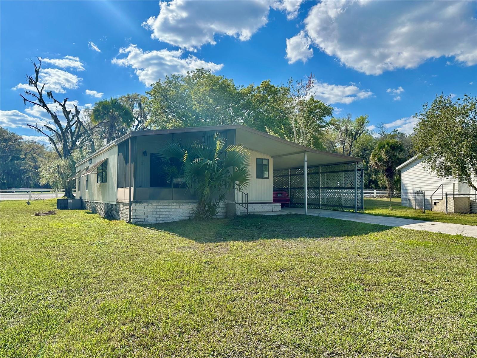 2 bedroom2 bath mobile with 2 car carport and handyman shop/storage area. Neutral colors but a little dated. It also features in unit laundry.