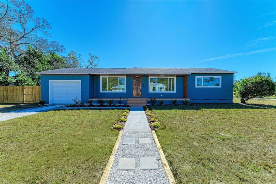 Exceptional, fully-renovated, luminous and welcoming home in the heart of North Kenwood! Everything is ready for you to enjoy! With brand new hurricane rated impact windows and not in a flood zone (flood zone X), you will live worry free! Nothing like impact windows for added security and peace of mind! The ROOF was replaced in 2020 and the AC in 2023. The GAS water heater and the well pump are both brand new. The home features all new insulation so you will save $$ on your power bill. The full kitchen was completely updated including brand new appliances: GAS range, refrigerator, microwave and dishwasher, new cabinets and quartz countertops. In addition you will find plenty of space for all your kitchen stuff in the large pantry closet. The bathroom was also fully renovated. Enjoy beautiful and worry free luxury vinyl laminate flooring installed in 2025. You will love the brand new back patio which is perfect for outdoor living. This freshly painted home is on a corner lot and has new fencing in the backyard. The oversized one car GARAGE features laundry hookups (including gas hookup for your gas dryer!) and plenty of storage for your car plus toys. There is also a genuine Wally Watt shed in the backyard. Further, the power lines for this home have been buried- so fewer power outages. Situated in North Kenwood you are close to everything! It is a quick drive to downtown or the beaches. Booker Creek Park is located just a few blocks away. With no renovations to worry about, you can just kick back and relax on your large front porch. Set up your private showing today!