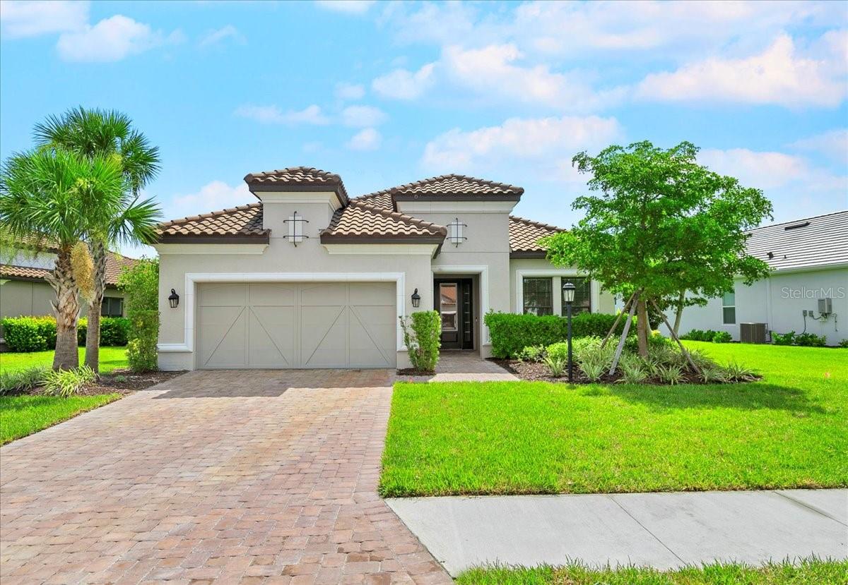 Stop your search—this is the one! Welcome to this stunning three-bedroom, three-bathroom home, formerly a sales center and never lived in. With over 2,300 square feet of living space, this residence offers ample room to spread out. Upon entering through the foyer, you'll find yourself in the heart of the home—a great room that seamlessly connects to the dining area and overlooks the kitchen, making it ideal for entertaining. The designer kitchen is equipped to meet all your culinary needs, featuring stainless steel appliances, pantry, and a large island complete with a breakfast bar. Enjoy casual meals in the dinette area. The flex space can be tailored to your needs, serving as an office or study to help you achieve your goals. Retreat to the primary suite, which boasts a bay window and an ensuite bathroom featuring dual vanities, spacious shower, and walk-in closet. Additionally, there are two generously sized bedrooms, one of which includes its own ensuite bathroom. Open the sliding glass doors in the great room to discover an expansive lanai, perfect for outdoor living while overlooking a tranquil pond. Relax under the covered section, which includes an outdoor kitchen, or bask in the sun in the open area, all within a fully screened enclosure. Completing this home is a three-car garage configured in tandem style, offering ample parking and storage space. Esplanade at The Heights provides a resort-style lifestyle with an impressive array of amenities, including a sparkling pool and spa, cabana area, fitness center, and lighted racquet and bocce courts. An on-site Lifestyle Manager is available to organize enjoyable events and community celebrations. Conveniently located near State Road 70 and University Parkway, this stylish community offers easy access to shopping, dining, outdoor recreation, and stunning west coast FL beaches. Don’t miss the opportunity to make this exceptional home your own!