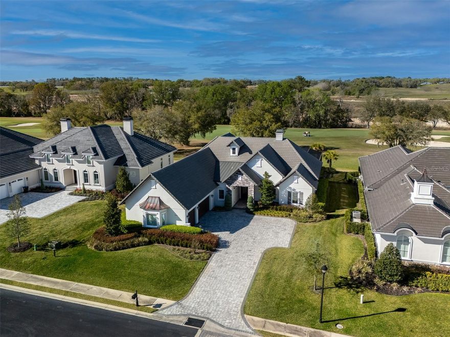 Nestled in the Brittany Estates neighborhood of Golden Ocala Golf and Equestrian Club, this stunning 3-bedroom plus study/den, 3 full bath/2 half bath home offers the perfect blend of luxury, comfort, and location! This beautifully landscaped .36-acre property is situated next door to the World Equestrian Center, with convenient golf cart access to their world-class amenities, and is less than five minutes away from all the excitement it has to offer. The home boasts a prime golf course view of the Muirfield tribute hole on Golden Ocala’s championship course. Inside the home, you'll find high tray ceilings, beautiful crown molding, an elegant wet bar, and an open, airy design with engineered hardwood and tile flooring throughout. Every bedroom closet and the pantry feature custom shelving, offering spacious, organized storage. The expansive kitchen is equipped with sleek stone countertops, a large central island, ample cabinet space, and perfect lighting that enhances its bright, inviting atmosphere. A cozy den with built-in wall-to-wall cabinets provides an ideal space for relaxation or as a home office. Sliding glass doors seamlessly connect the indoor living space to the expansive screened-in back patio, featuring a spacious lounge area, outdoor kitchen, and fireplace—perfect for entertaining! Enjoy year-round relaxation in the heated saltwater pool and spa area, complete with an outdoor shower and pool bath, while overlooking serene views of the golf course. A 3-car garage adds even more convenience and space to this exceptional property, making it the perfect place to call home!