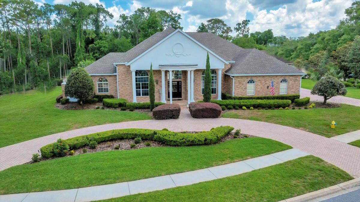 A HOME STRAIGHT OUT OF A FAIRYTALE. Set behind the GUARDED GATES of an exclusive community on a HALF-ACRE LOT WITH RIVER ACCESS, this professionally designed home enchants with high-end finishes and a CHEF'S KITCHEN so stunning, it feels like a dream come true. Set on a quiet cul-de-sac, this brick-front beauty offers 3 BEDROOMS plus an OFFICE, soaring ceilings, TRAVERTINE AND HARDWOOD FLOORS, and a HEATED POOL that feels more like a private boutique hotel escape than your own backyard. A brick paver CIRCULAR DRIVEWAY offers a warm welcome for guests, leading to a classic brick façade with columns flanking the front entry and a front porch overlooking a peaceful water feature and fountain. A second paver driveway leads to the side-entry garage, perfect for owners' everyday coming and going. Step into a grand foyer with soaring ceilings and travertine floors that set the stage for what's to come. The elevated formal living room makes a statement, while the formal dining room sits just beside it, both spaces glowing under gorgeous designer lighting. And then there's the kitchen—the true heart of this home and nothing short of spectacular. Completely renovated just a few years ago, it's a dream for anyone who loves to cook or entertain. SOLID WOOD CABINETS add classic beauty, paired with QUARTZ countertops that shimmer with timeless style. A custom hood crowns the WOLF GAS COOKTOP, while DOUBLE FRENCH OVENS stand ready for any grand gathering. There's a SUB-ZERO REFRIGERATOR, a wine refrigerator, and not just one full dishwasher, but also two dishwasher drawers to make cleanup feel like magic. And the TWO ISLANDS are impressively large, offering plenty of space for prepping, serving, or gathering with friends and family. The kitchen opens to the family room, where French doors lead out to the pool, and a GAS FIREPLACE WITH STONE SURROUND serves as the focal point. Just off the kitchen, there's also a small courtyard that brings a bit of the outdoors in. Ready to feel like royalty? The primary suite is fit for a princess, with hardwood floors and French doors that open to the lanai for a bit of morning sunshine or evening breezes. There are two roomy walk-in closets for all your wardrobe treasures. And wait until you see the bathroom—there's a soaking garden tub ,a walk-in shower that looks out to a SECRET GARDEN through a window, and beautiful hand-painted murals that bring the entire space to life. Just outside the primary bedroom, there's an office for work or quiet time. The split floor plan places two guest bedrooms on the opposite side of the home. One has an ensuite bath, while the other shares a bathroom that also doubles as the pool bath. Step outside, and the magic continues. A heated pool with a spillover SPA sparkles in the sun, while an OUTDOOR KITCHEN with a gas grill and bar seating is ready for gatherings. There's even an outdoor shower and a built-in open-flame grill. Beyond it all, the backyard feels like a hidden escape, with mature trees, lush greenery, and statues that add a touch of wonder. The property backs up to the WEEKI WACHEE RIVER, offering a beautiful natural backdrop. And living here means enjoying more than just the home—the community features a GUARDED GATE ENTRY, TENNIS AND BASKETBALL COURTS, and even a PRIVATE BEACH along the river. It's the kind of place that makes everyday life feel a little more special. NO CDD FEES AND NO FLOOD ZONE.