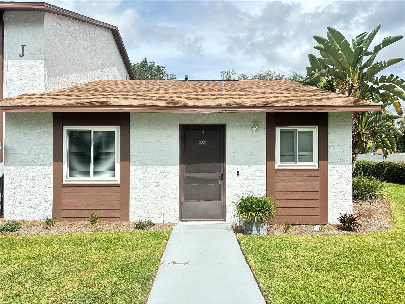 Call today to view this highly desirable 2 bed, 2 bath end/one story unit across from clubhouse and pool. Includes one covered carport space! Close to shopping, restaurants and hospitals. This unit has newer Waterproof laminate floors and dishwasher and also includes an in unit washer and dryer. You don't want to miss this one!!