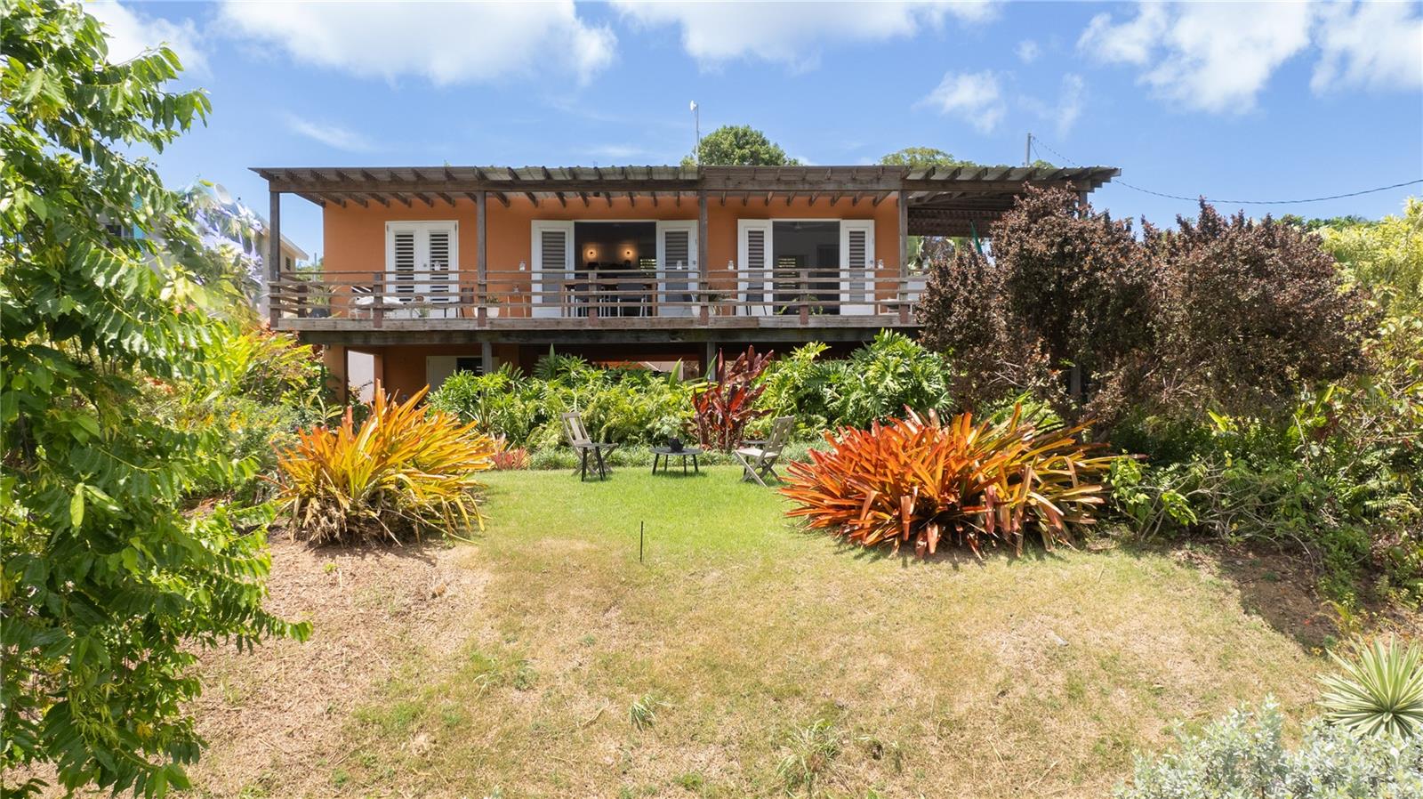 A nature lover’s dream! Casa Eden isn’t your typical home on the beautiful island of Vieques — it’s a curated experience where functionality and comfort meet one of the finest designed gardens on the island. This extraordinary setting is the result of over 15 years of dedication by acclaimed landscape artist Jeff Mendoza, who has poured his creativity and soul into every inch of the land.
Perched at the very top of the property, the house enjoys panoramic ocean views, gracefully framed by terraced gardens and lush foliage. A dynamic blend of native and exotic plant varieties flow through the landscape, creating a living masterpiece that evolves with every step and season.
Tucked away in a peaceful location, the property offers a true sense of privacy and calm — ideal for those seeking a quiet, nature-filled retreat. Surrounded by vibrant greenery and thoughtfully designed outdoor spaces, it feels like your own secluded oasis.
The home itself embodies elegant simplicity with an open, airy layout filled with natural light. A wide, covered terrace wraps around the living space, bringing filtered sunlight and cooling breezes throughout. The central living area seamlessly connects the kitchen and lounge area to the outdoors through double French doors, opening onto the spacious terrace — a perfect setting for dining, relaxing, or simply soaking in the breathtaking northern ocean views.
The primary bedroom overlooks the horizon and includes an en-suite bathroom. On the opposite side of the house, a guest bedroom and bathroom provide privacy and comfort for visitors. The lower level features a large storage room and shaded parking area. This flexible space could be converted into a guest suite, rental unit, or additional living area to suit your needs.
Adding to its appeal, the house is equipped with a solar energy system — offering sustainable, off-grid living with modern comfort. It's an ideal setup for those seeking a more independent and environmentally conscious lifestyle.
Casa Eden is more than just a home — it's a lifestyle. Designed and nurtured by renowned landscape artist Jeff Mendoza, this property harmonizes thoughtful architecture, lush design, and natural serenity. With stunning views, solar-powered sustainability, total privacy, and a peaceful ambiance, it offers a rare opportunity to live in beauty and tranquility on the island of Vieques.