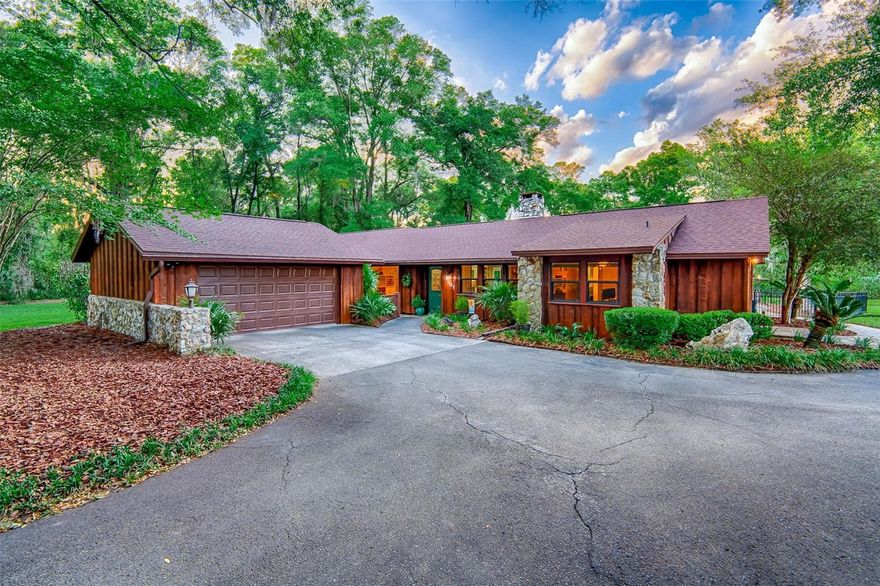 One or more photo(s) has been virtually staged. Tucked behind a private gated drive on a beautifully maintained and fully fenced 2.8-acre lot, this exceptional single-story ranch offers the perfect blend of country privacy and Gainesville convenience. Located just minutes from I-75 and backing up to Jonesville Park, this property delivers space, flexibility, and extensive recent upgrades. The home is configured as 5 bedrooms and 3 bathrooms with 3,061 heated and cooled SF, plus an additional bonus room or den ideal for a home office, playroom, or flex space. Inside, you’ll find updated flooring, paint, baseboards, trim, and interior doors, along with energy-efficient vinyl CWS windows and sliding door, a double-sided fireplace, walk-in pantry, and a spacious mud room with storage cabinets, wash tub, and washer/dryer. Major updates include a new A/C in 2021, new roof in 2023, two new hot water heaters in 2023, and a new insulated garage door and opener in 2022.  Outdoor living truly sets this property apart, with a remodeled and resurfaced PebbleTec pool, approximately 2,500 SF of pavers, a gazebo with lighting, fan, and power, spacious covered porch with enclosed TV and automatic roll-up screens, all completed in 2024. A top of the line double bay metal building built in 2022 adds incredible versatility with 1,550 SF of enclosed space, 16-foot eave height, two insulated 12' x 14' garage doors, insulated ceiling, 4K interior lighting, thermostat-driven wall fan, galvanized steel conduit, abundant receptacles, a 50-amp RV or welding receptacle, 720 SF of additional covered parking, and ample exterior lighting. Ideal for RV and/or boat storage, workshop use, hobby space, or even a private sports training area such as a batting cage. The property also includes a 215 SF detached storage building with an A/C window unit.  Zoned for excellent Gainesville schools like Meadowbrook Elementary and Buchholz High School.  Minutes from shopping and restaurants in Jonesville and Tioga Town Center.  This is a rare opportunity where space, privacy, and convenience come together.  Schedule your private showing today and experience it for yourself before it's gone.