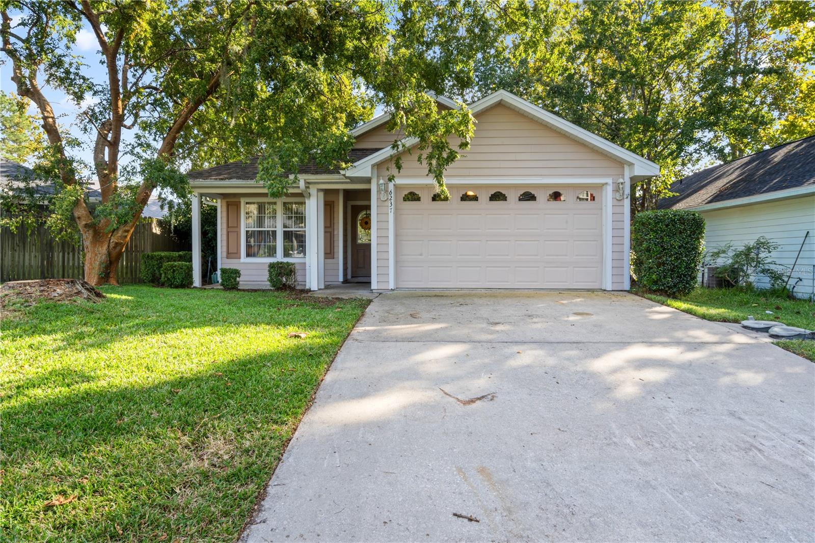 Nestled in the serene gated golf course community of Turkey Creek, this move-in ready 3 bed, 2 bath home offers 1,263 square feet of comfortable living space. Step inside to find an open and inviting layout with high ceilings, updated flooring, and tons of natural light. The spacious kitchen offers plenty of cabinet space and flows seamlessly into the dining and living areas, perfect for entertaining. The primary suite features a tray ceiling, walk-in closet, and spa-style bathroom with double vanities, a tiled shower, and jetted tub. Two guest bedrooms and a full bath complete the split floor plan. Enjoy your morning coffee on the screened back porch overlooking a peaceful fenced in backyard with a new large concrete patio. Recent updates include a newer HVAC (2022), new roof (2024) and new water heater (2024), offering worry-free living for years to come. As a Turkey Creek resident, you will enjoy access to the community pool, clubhouse, restaurant, tennis and pickleball courts, playground, basketball courts and the beautifully maintained golf course, all just minutes to Gainesville and downtown Alachua. Call today to schedule a private tour today!