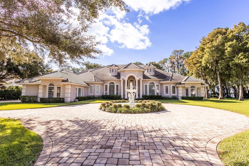 This exceptional estate, situated within the renowned guard-closed gated Cypress Point community on the stunning Butler Chain, is truly unique. Upon entry, you're greeted by breathtaking views of the pristine Lake Sheen spanning 167 feet. The grand foyer showcases 20-foot ceilings and expansive windows, filling the home with natural light. Perfect for hosting, it boasts a formal dining room and game room, both adorned with exquisite imported chandeliers. The kitchen is a chef's paradise, featuring a built-in gourmet coffee machine, gas cooktop, professional steamer, and top-notch appliances. 4 suites downstairs and 2 suites upstairs. The master suite is a serene retreat, leading to a spacious closet and a luxurious spa bathroom with a steam shower and views of Lake Sheen. A full cine room, a game room and a library. Outdoors, you'll find a resort-style pool, hot tub, summer kitchen, covered seating area, and fire pit, all overlooking the lake. A private dock provides access to the Butler Chain of lakes and a delightful spot to enjoy sunsets and Disney fireworks.
Extra features: Ring Camera Front Door
TP-Link KASA Smart Switches and Dimmers throughout house
TP-Link KASA Smart Switches, Dimmers, and Color LED Bulbs in 5 bedrooms
Automatic Shades in 3 bedrooms
Automatic Curtains in Master Bathroom
Smart Door Lock (Front door + garage)
Smart HVAC Honeywell Home System
Sonos Home Audio Speaker System (House:Bedroom 1, Game Room,Bedroom 2, Master Bedroom+Bathroom, Outside (over fireplace area/entire covered area) (speaker+soundbar+sub+amp system in movie theater) + (sound bar in game room).
This is a rare opportunity to acquire a fully remodeled dream home in Cypress Point – a true must-see.