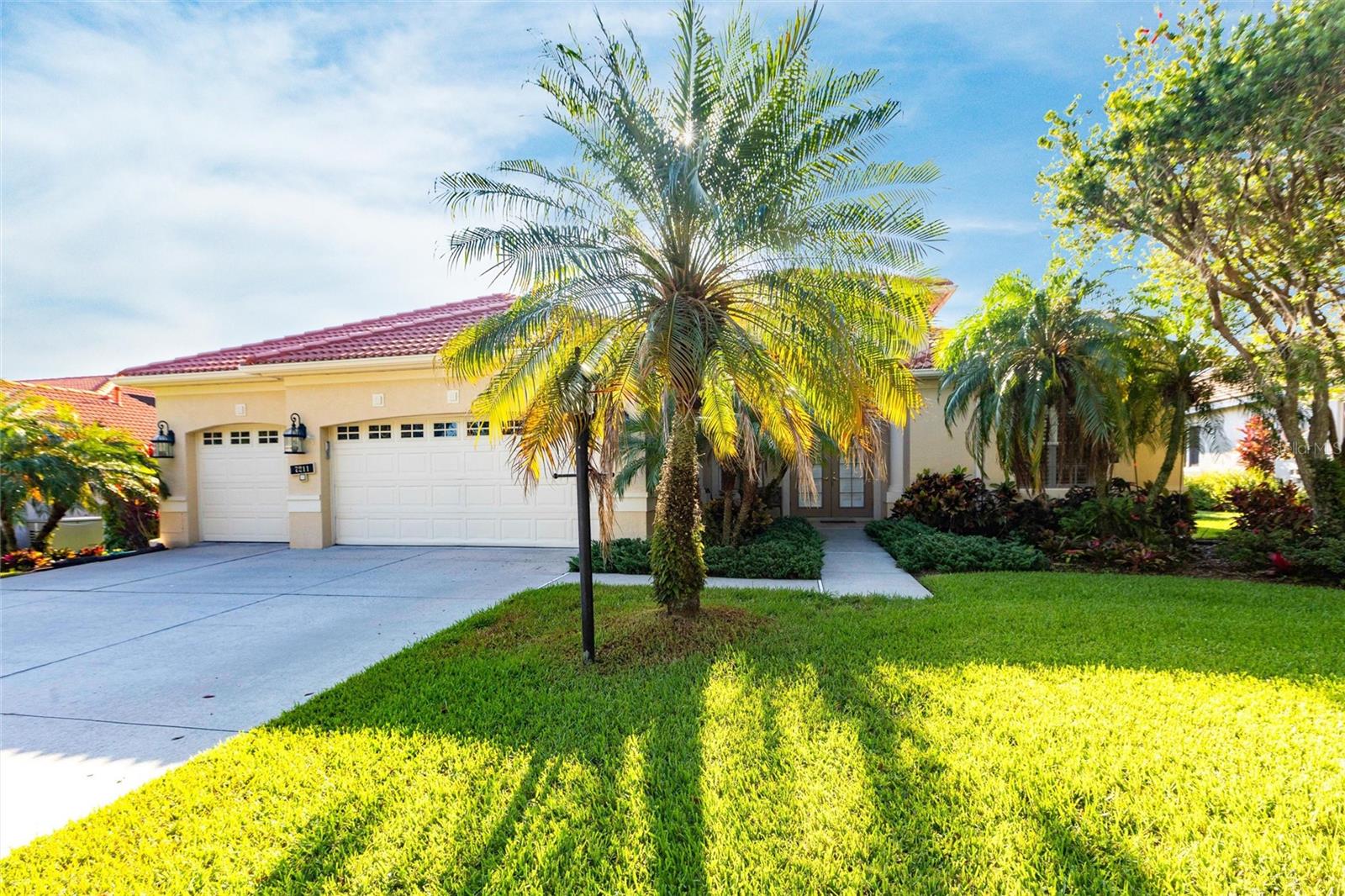 Welcome to 7211 Treymore Ct., an elegant and meticulously maintained residence nestled in the exclusive gated community of Treymore at the Villages of Palm Aire, one of Sarasota’s most sought-after neighborhoods. This impeccably maintained home offers a harmonious blend of luxury, comfort, and privacy, all within minutes of Downtown Sarasota, Downtown Bradenton, and the amenities of University Town Center.
This thoughtfully designed home features three bedrooms, three bathrooms, a versatile office with French doors that can serve either as a den or fourth bedroom, and a large three-car attached garage. Set on a beautifully landscaped lot, the property boasts both front and rear open porches, with the rear porches leading to a stunning screen-enclosed pool! Perfectly accenting the pool is an outdoor grill area designed for entertaining, complete with grill, wall mounted TV, microwave and minifridge. Truly your own private retreat, ideal for entertaining or relaxing in your Florida oasis!
The interior offers a generous living area and showcases quality craftsmanship throughout, providing ample room for luxury living and entertainment. Wood and tile flooring extend across the entire home, creating a warm, inviting ambiance. The gourmet kitchen is a true centerpiece, featuring granite countertops, a large granite-topped wet island, a mirror backsplash, and updated stainless steel appliances. Custom millwork accents include elegant door and window casings, crown molding, and tray ceilings in both the family room and master suite, adding architectural charm and dimension.
The master bedroom suite is a true highlight of the home and includes a walk-in closet with built-in shelving, plantation shutters and glass sliding doors to the pool/patio! The master bathroom features dual vanities, a tub and walk in shower. The secondary bathrooms are equally refined with granite vanities. A full laundry room includes a utility sink and washer/dryer.
From the barrel tile roof to the custom French doors at both the front entry and office, every detail of this home reflects quality and care. Built to high standards and in excellent overall condition, this home is truly move-in ready. Conveniently located just minutes from top-rated schools, healthcare, golf courses, shopping, dining, and I-75 for quick access to the best of the Suncoast. Don’t miss your opportunity to own a move-in-ready home in one of Sarasota’s premier gated communities!