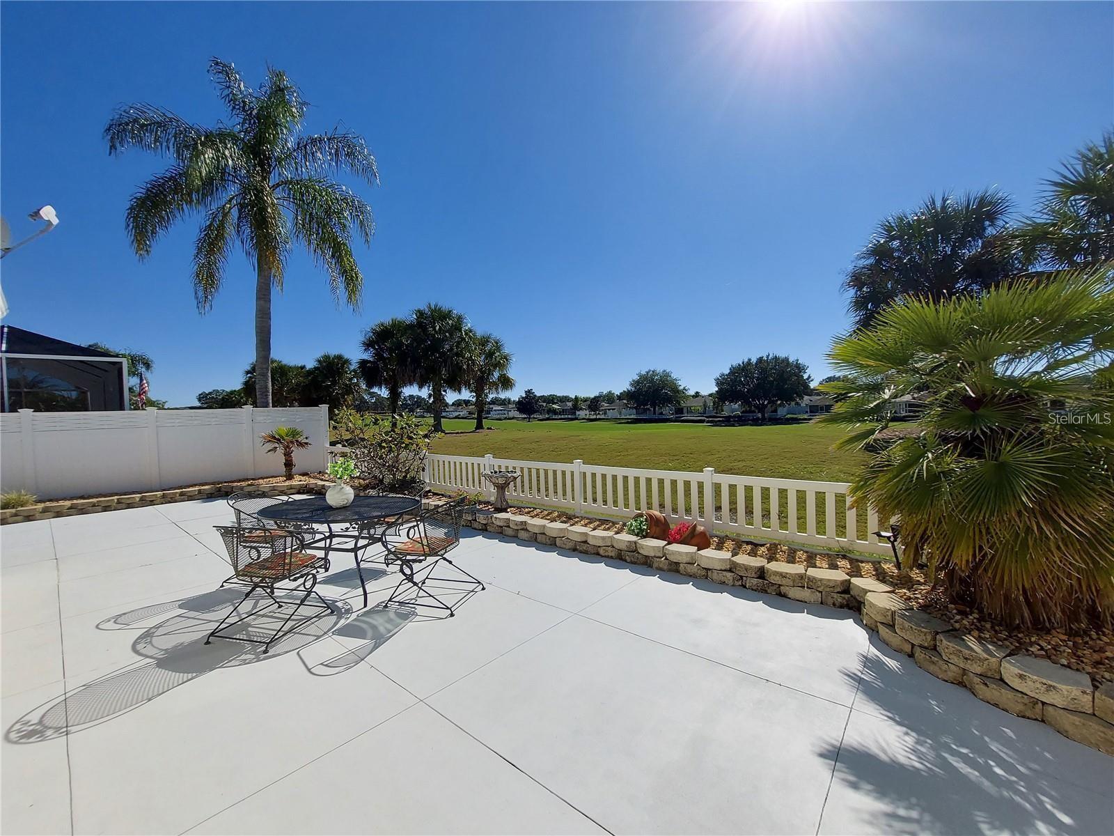 SEASONAL RENTAL! GOLF FRONT COURTYARD VILLA - 5TH GREEN OF NANCY LOPEZ CHAMPIONSHIP GOLF COURSE. Spacious open patios along the side and across the back of the villa, are equipped with a GAS GRILL and multiple seating and dining options to enjoy WATCHING GOLFERS chip and putt or just take in the Florida sunshine. There is a MEDIA ROOM with POWER RECLINING LOVESEAT and SMART TV. GRANITE countertops, white cabinets and STAINLESS APPLIANCES make the kitchen a very enjoyable spot for preparing meals when you're not taking advantage of the many dining options in and around The Villages. The pendant lights and BREAKFAST COUNTER, which is open to the dining area, make entertaining or every day living a breeze. The open floor plan flows very well through the nicely furnished dining area and living room which are open to the Florida Room offering great GOLF COURSE VIEWS. The PRIMARY BEDROOM has queen bed, WALK IN CLOSET and EN SUITE BATH with WALK IN SHOWER and GRANITE countertop. The GUEST AREA is adjacent to the dining area and has a pocket door entry, offering nice privacy. The guest bedroom which has a queen bed and a good size wall closet is adjacent to the UPDATED GUEST BATH with TUB/SHOWER combo, and GRANITE countertop. There is an inside laundry room with full size washer and dryer. Stay up to date with work or emails at the office area set up in the garage with large screen computer monitor/tv and printer. This rental also includes the use of a 2013 EZGO GAS GOLF CART and 2 SETS of GOLF CLUBS. There is a $50 fee payable to The Villages Community Development District for each Lifestyle ID, which will give you access to enjoy the golf, rec centers, pools, clubs, shuffleboard, tennis, pickle ball and other activities duriing your stay. Located less than 1/4 mile to Mulberry Rec Center and pool, Walgreens, Mulberry Plaza with restaurants, Publix grocery store, medical offices, VA Outpatient Center. Just moments to one of the best restaurants in the Villages, Legacy Restaurant at Nancy Lopez CC. Also close to Glenview CC, Savannah Center, many golf course options and many other shopping options. Enjoy a number of live performance and concert venues, live music at many restaurants and FREE NIGHTLY ENTERTAINNMENT at Spanish Springs, Lake Sumter Landing and Brownwood town squares. Renter pays online Rentspree application fee of $49.