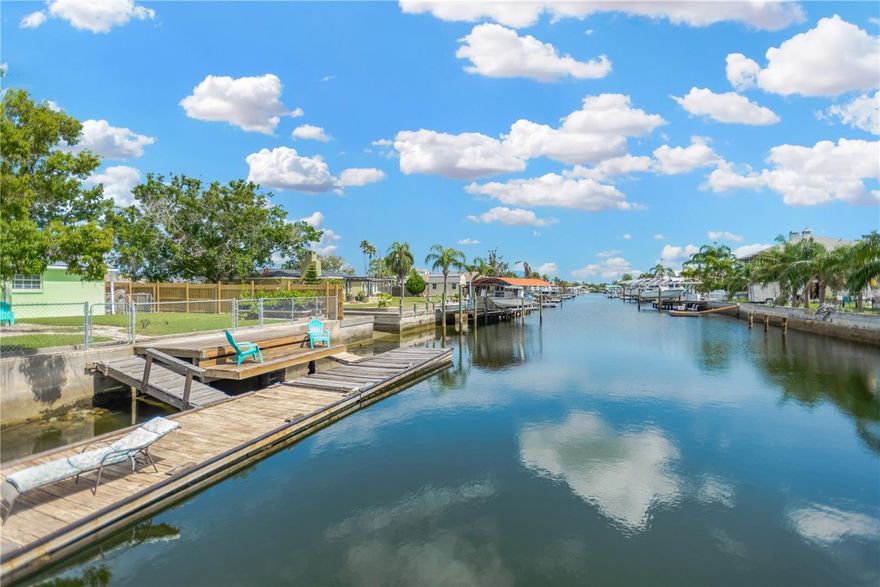 Live the ultimate coastal lifestyle in this beautifully renovated waterfront home that sits on 0.23 acres corner lot in the areas most desirable waterfront community. This open and spacious 3 bedroom / 2 bath home + Bonus Room and 2 car garage has direct Gulf of America access, 40 ft floating dock and upper main dock that was redone in 2021. Enjoy 110 ft of water frontage on a deep canal, this home is perfect for the boating, jet skiing, fishing enthusiasts that desire a coastal lifestyle and endless waterfront adventures. Golf cart owners ~~ this is a golf cart friendly community as well. This sparkling home offers sleek, modern finishes with NEW: kitchen w/shaker light cabinetry, soft close drawers, quartz countertops ** beautifully appointed tile master and guest bathrooms ** LG stainless kitchen appliance package ** A/C unit (2024) ** Water Heater (2026) ** Garage door motor replaced (2026) ** easy care vinyl plank style flooring in main areas /guest bedroom ** interior paint / neutral color. Other key features include boat and trailer parking on both sides of home ** RV hookup with water, electric and sewer available ** outdoor shower area ** expansive enclosed Florida Room/Porch front of the home for added living space. Just minutes away from marinas, public boat ramps, a myriad of waterfront restaurants, local beach, fun tiki bars/entertainment and more. Easy access to US 19, Suncoast Parkway, Tampa International and more. Call to schedule your private viewing today ~~ you are sure to fall in love with this exceptional home.  (Home is now a blank slate for easy move in; sellers have since removed their furniture)