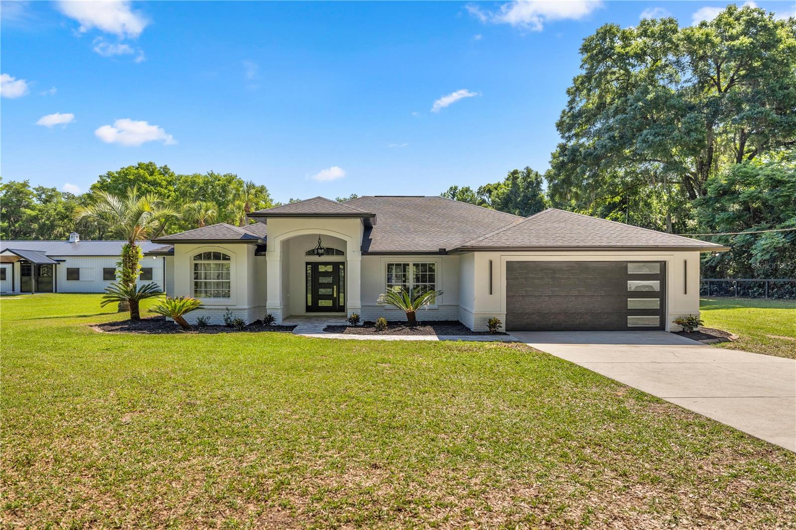 Time to make this 5 Acre Farm your New Home. Enjoy privacy and serenity of rural country living, just 20 minutes to the World Equestrian Center and The Ocala Horse Park and just minutes from shopping! This home has undergone recent renovations from Top to bottom. This home has a new roof, lighting, flooring, appliances, and so much more. It is open and airy, with a beautiful modern feel. The screened back porch looks out to your beautiful new 10 stall barn, with center aisle pavers and 2 areas for tack room and office space. Come take look at this perfect farm.