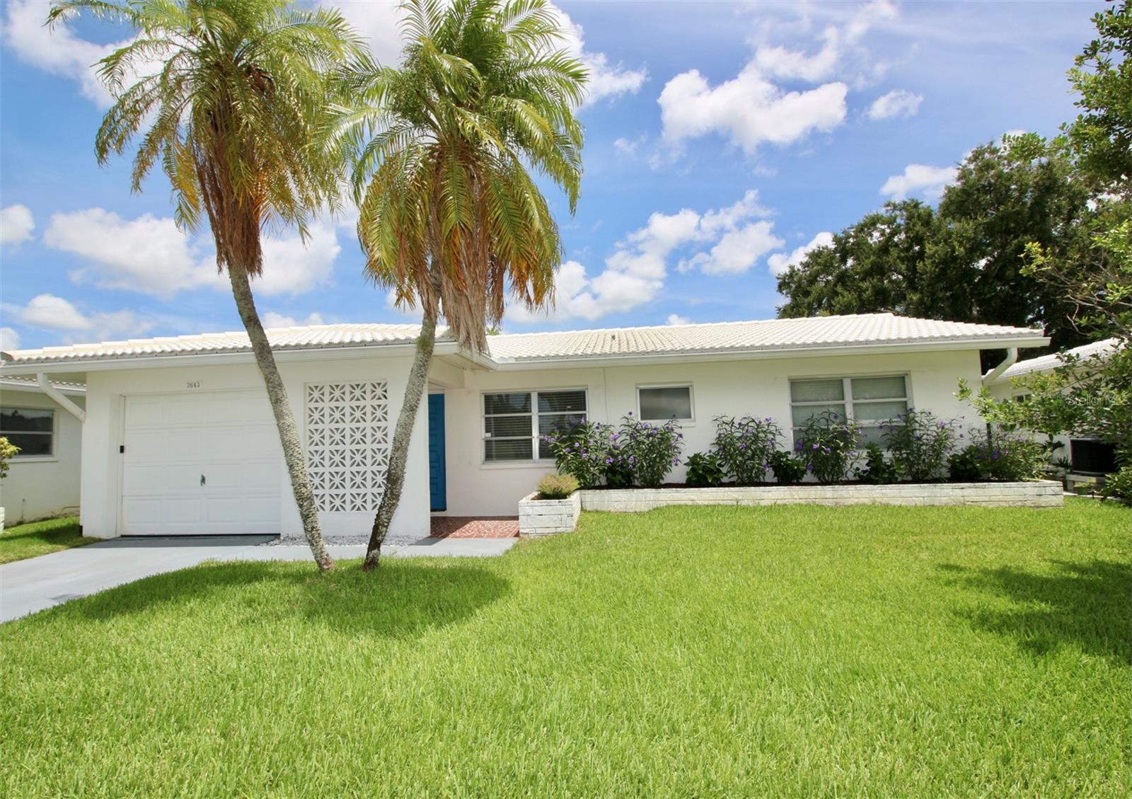 **MAINLANDS OF TAMARAC BY THE GULF SHOWPLACE** Beautifully renovated 2-bedroom, 2 full bath open floorplan built to entertain all of your family and friends. Featuring new crown molding, 6 panel interior doors with nickel plated doorknobs, durable tile and luxury vinyl plank flooring, window blinds and freshly textured ceiling throughout. Gorgeous Chef's kitchen with brand new quartz countertops, breakfast bar, cabinets, deep stainless-steel waterfall workstation kitchen sink with automatic glass rinser and separate serving counter with lots of pantry space. Kitchen overlooks the huge family room with lots of natural light and back patio access. Primary bedroom has a large walk-in closet with organized closet system and updated private bath with round vessel sink and quartz vanity, LED anti-fog mirror, low step in tile surround shower and heavy-duty custom glass shower door. Second bedroom also has a walk-in closet with organized storage system. Updated guest bath has a tub/shower combo with surround tile and again heavy-duty roller custom glass door, quartz countertop vanity, brilliant ceramic hexagon tile flooring and LED anti-fog mirror. New 2024 Rheem AC system and water heater. Solid Block home with tile roof that is maintained by the HOA. Oversized one car garage with new automatic door opener, full size stackable LG washer and dryer, utility sink, steel side door and attic pull down stairs access. Covered front porch. High and dry flood zone X. Spectacular landscaped yard with irrigation system and rear patio outdoor living area. Wonderful opportunity to be the new owner in one of Pinellas Counties Elite 55+ active resident and golf cart friendly communities with a low monthly fee of only $450.00! Tropical Florida Lifestyle Living offering a short walk to the sparkling in ground pool, shuffleboard courts, clubhouse and endless scheduled activities. HOA includes the roof, exterior painting and maintenance, lawn service, cable tv, internet, water, sewer and trash. Easy access to Tampa, Clearwater, St. Petersburg, all major highways, interstates and Our World-Famous Sugar Sand Beaches! Call and schedule your private showing and make this your Florida Staycation home today!
