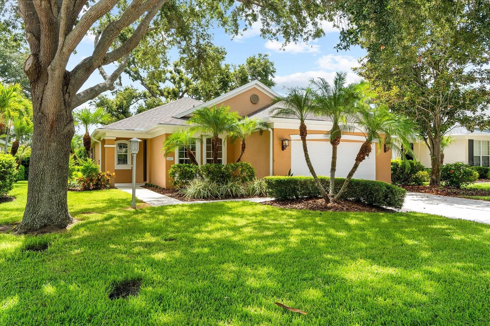 Welcome to Harborage a gated community that offers a tranquil coastal retreat. This charming home is the perfect blend of modern comfort and laid-back coastal living with MAINTENANCE INCLUDED and NO FLOOD insurance required. Just steps from scenic walking trails and peaceful waterways, you’ll enjoy lush natural surroundings, a private MARINA, and a vibrant yet serene lifestyle. The home features a brand NEW ROOF and light-filled open living spaces with vaulted ceilings and large windows that frame the beautiful landscaping. Neutral tones and natural elements throughout the interior create a welcoming and relaxed atmosphere. The spacious living and dining area is ideal for both entertaining and quiet nights in. The kitchen includes stainless steel appliances, generous cabinetry, a pantry, a breakfast bar, and a cozy eat-in area. The large primary suite offers calming views of the greenery, along with dual walk-in closets and an ensuite bathroom with a walk-in shower, dual sinks, and a linen closet. Additional bedrooms share a full bathroom. And the laundry room complete with a rustic barn door provides direct access to the garage. This home also offers a spacious patio for relaxing or entertaining. Residents of Harborage enjoy access to a private marina and dock (available for a minimal fee), a resort-style heated pool and spa, clubhouse with both indoor and outdoor entertaining spaces, a fitness center, dog park, playground, walking trails, and canoe/kayak launch. This Key West-inspired community blends natural beauty with everyday convenience and is ideally located near shopping, dining, and recreational options including Gulf Coast Beaches and only 8 miles from Sarasota Airport. Live the relaxed Florida lifestyle in this welcoming home where everything you need is right at your fingertips.