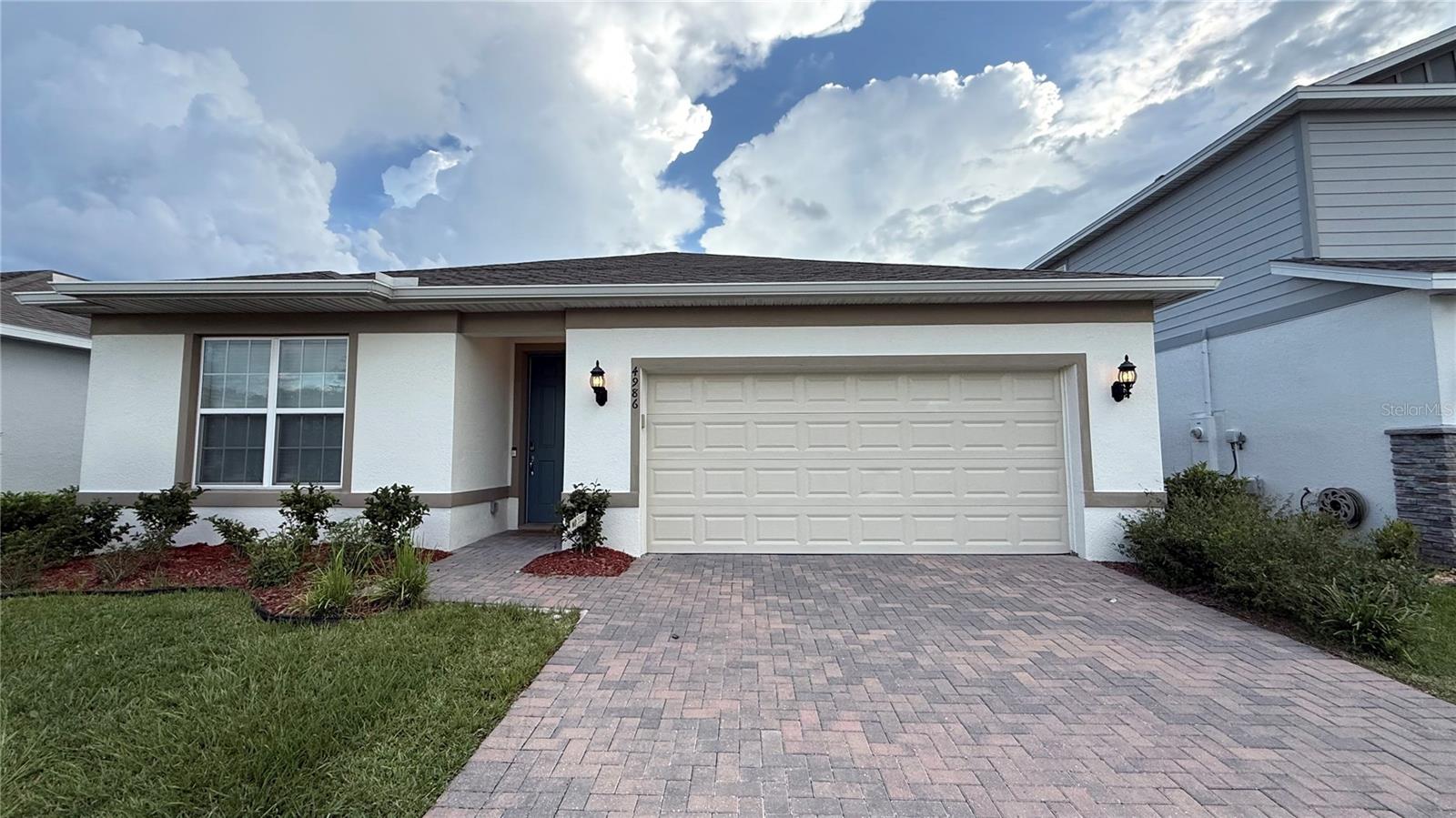 Welcome to this stunning 3-bedroom, 2-bath home featuring a modern open floor plan and elegant finishes throughout. Enjoy tile flooring across the entire house – no carpet! The gourmet kitchen offers quartz countertops, stainless steel appliances, and a modern refrigerator, perfect for family meals and entertaining. The spacious bedrooms are filled with natural light, enhanced by modern ceiling lights. The bathrooms feature smart LED mirrors with dimmable light and anti-fog technology for a luxury touch. The large living and dining area shines with crystal chandeliers and modern blinds, creating a warm and inviting atmosphere. Step outside to a covered lanai with ceiling fan and breathtaking lake views, also visible from the master bedroom. The property includes a 2-car covered garage plus extra parking for 2 more vehicles. Located just steps from community amenities such as a pool, BBQ area, playground, close to schools, restaurants, shopping centers, and more. Don’t miss this chance to live in one of Kissimmee’s most desirable communities!