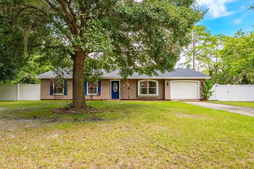One or more photo(s) has been virtually staged. **Ask about a lender provided RATE BUY-DOWN CREDIT on this home!**Seller may consider buyer concessions if made in an offer**Set on a sprawling 1.71-ACRE DOUBLE PARCEL in Plantation Estates of DeBary, this 3-bedroom, 2-bath home offers room to breathe, modern updates, and endless potential SURROUNDED BY NATURAL BEAUTY. With tranquil conservation land and a natural water feature stretching behind the property, this is a rare opportunity to enjoy PRIVACY, SPACE, and CONVENIENCE all in one. RECENT UPDATES bring comfort and confidence, including a NEW ROOF (2025), NEW CONCRETE PORCH, and an UPDATED GUEST BATH. Inside, NEWER LAMINATE FLOORING enhances the Living room and Office, while all bedrooms also feature laminate flooring for easy care and a cohesive look. The Living and Dining combination is open and inviting, with a TRAY CEILING and arched cutouts adding a touch of architectural style. SLIDING BARN DOORS reveal a large Office with BUILT-IN SHELVING, a versatile bonus space converted from the garage—perfect for working from home or pursuing hobbies. A graceful curved doorway leads to the Kitchen, complete with SOLID WOOD CABINETRY, tile countertops, and a breakfast bar, ideal for casual meals or morning coffee. The Primary Bedroom offers an EN SUITE BATH, while two additional bedrooms provide plenty of space for family or guests. Step outside to enjoy a covered patio overlooking the EXPANSIVE BACKYARD, where you can unwind, entertain, or take in the surrounding PEACE and PRIVACY. Practical features like an RV HOOKUP, electrical connection for a whole-house generator, and NO HOA make this property as functional as it is inviting. There’s truly so much potential for what you can do with the land. Located close to Gemini Springs Park, DeBary Hall Historic Site, and the St. Johns River, OUTDOOR ADVENTURES are always nearby. Easy access to I-4 and US-17/92 makes commuting simple, with Sanford, Lake Mary, Orange City, and Deltona all within minutes—and both DAYTONA BEACH and DOWNTOWN ORLANDO less than an hour away. SPACIOUS, UPDATED, and surrounded by NATURAL BEAUTY, this Plantation Estates home provides a lifestyle of comfort, flexibility, and opportunity. Don't miss your chance to call this Home!