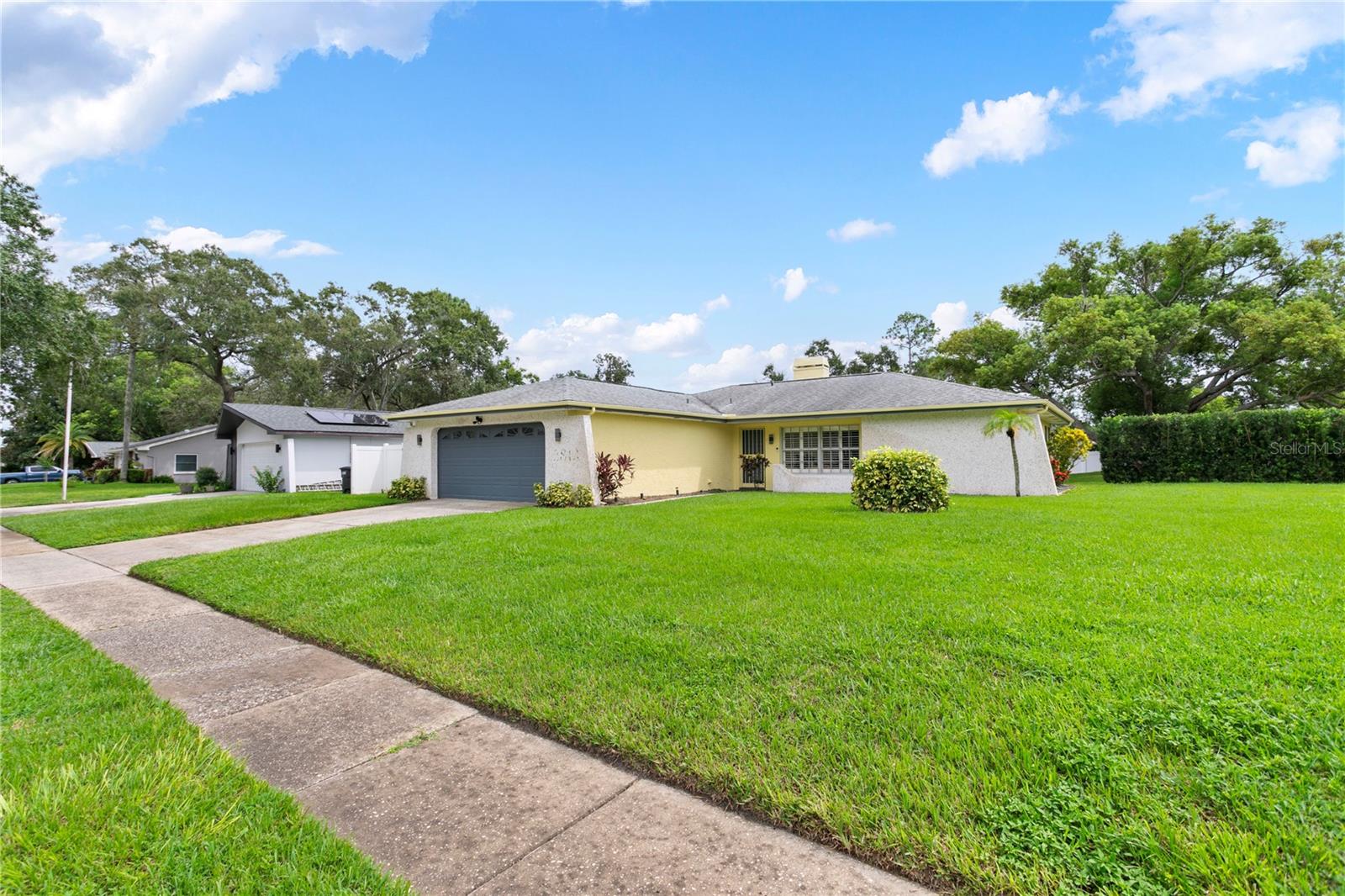 Welcome to this beautifully updated 2 bedroom, 2 bathroom pool home, gracefully situated on an oversized corner lot of more than a quarter acre in the heart of Clearwater. From the moment you arrive, the curb appeal and lush landscaping set the tone for what awaits inside. Step through the front door and discover a bright, open layout where the living and dining spaces flow seamlessly together, highlighted by warm accents that create a comfortable yet stylish atmosphere. The kitchen is filled with natural light and thoughtfully designed with abundant cabinet space and a sleek gas over-range with hood — a true delight for any home chef. Windows overlooking the patio and pool invite the outdoors in, making meal preparation and entertaining both effortless and enjoyable. The primary suite offers a peaceful retreat with its private bath and walk-in shower, while the guest bedroom and second full bath are tucked away for added privacy, making this layout ideal for hosting family or friends. Step outside to your own backyard oasis, where a large covered patio extends
to a sparkling screened-in saltwater pool. With a brand-new pump, filter, and equipment, this pool is ready for year-round enjoyment — whether you’re entertaining guests, swimming laps, or simply relaxing in the Florida sunshine. Mature shrubs and landscaping surround the property, offering privacy and a sense of tranquility rarely found so close to the city. Thoughtful upgrades ensure worry-free living, including a two-year-old 22kW whole-home generator that automatically powers every appliance during an outage, stylish new tile flooring throughout the living areas, and all kitchen appliances less than three years old. Additional conveniences include a garage with utility sink, rain gutters and pre-plumbing for a water softener. Perfectly positioned near top-rated schools, shopping, dining, and the beautiful Gulf beaches, this home offers not only comfort and functionality but also the ultimate Florida lifestyle. Don’t miss the opportunity to make this
Clearwater retreat your own — schedule your private showing today.