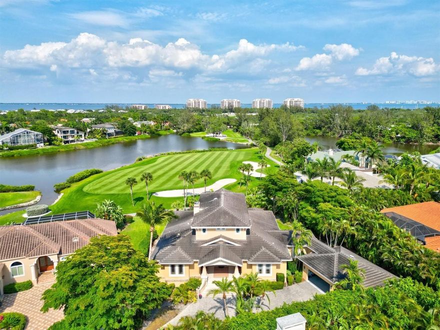 Situated behind the exclusive gates of Bay Isles & the resort community of The Longboat Key Club. This lovingly maintained home offers golf course and private lake views. A large sweeping driveway leads directly into three car garage and inviting covered front veranda. Upon arrival be welcomed by a dramatic 20 foot ceiling Great Room with comforting hardwood floors throughout. Choose between two primary suites; first floor suite with spa like bathroom or the completely private upstairs suite with covered balcony delivering expansive views. Both guest bedrooms mirror each other with their own full en-suite bathroom. Dine in the great room or in the perfectly situated breakfast nook while gazing out at your lush backyard and golf course. This open kitchen checks every box with top of the line appliances, private wet bar, pantry, sitting desk, and bar seat counters. Directly off the kitchen is a considerable sized laundry room and den which could be used as a gym or office. Beautiful backyard has pool, spa, outdoor grill, and fire pit or relax outside in the screened in Florida room offering both indoor and outdoor living, perfect for entertaining outside or just some quite time by yourself bird watching. Included in your homeowners fee is a membership to The Bay Isles community which offers private access to its own Gulf Beach Club, large covered pavilion available to reserve for parties, parking, restrooms and showers, along with covered picnic tables and barbecue stands, all situated on the Gulf of Mexico.  Memberships are available to The Longboat Key Club boasting 45 holes of golf, 20 Har-Tru tennis courts, fitness center, spa, fine dining & restaurants a short drive to St. Armands.