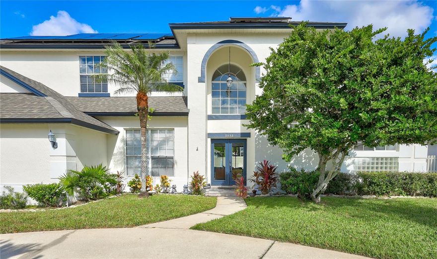 Timeless elegance meets contemporary luxury in the heart of Hunters Creek. From the moment you arrive, a stately circular driveway, secondary side entry, and abundant guest parking set the tone for the grandeur within. A new roof (2022) and fully paid-off solar panel system (2023) deliver lasting value and energy savings from day one. Inside, large-format marble porcelain tile flows throughout an open-concept layout anchored by a custom entertainment wall with wood-textured paneling, floating console, sleek electric fireplace, and designer lighting. The show stopping kitchen features gold-hardware cabinetry, a bold navy waterfall island, quartz countertops, high-end stainless steel and glass appliances, and a sculptural LED chandelier — where cooking and entertaining are equally inspired. Outside, your private backyard oasis awaits: a sparkling pool and spa surrounded by lush artificial turf, a stone-paved patio, rustic-modern pergola, outdoor shower, and a convenient half bath — resort-style living at home. The primary suite is tucked on the main floor for privacy and ease, with four additional bedrooms upstairs. Every detail deliberately chosen. Every finish beautifully realized. Hunters Creek was built for those who love to move. Residents enjoy an impressive array of recreational amenities including tennis and pickleball courts, volleyball and sand volleyball courts, basketball courts, soccer fields, and baseball diamonds — all within the community. Whether you're a seasoned athlete or just looking for a friendly game with neighbors, there's always something going on.Few communities offer the kind of convenience Hunters Creek delivers. Walt Disney World and the broader theme park corridor are just minutes away, making weekend magic effortless. Orlando International Airport is a quick, easy drive — a huge plus for frequent travelers and professionals alike. Downtown Orlando, with its thriving dining, arts, and nightlife scene, is equally accessible, and the surrounding area is rich with employment opportunities across tourism, tech, healthcare, and beyond. Tree-lined streets, well-kept parks, and a genuine sense of community set Hunters Creek apart. It's a place where neighbors become friends, and every amenity you need — from shopping and dining to recreation and green space — is right at your fingertips.Hunters Creek is served by some of Orange County's most highly regarded schools.