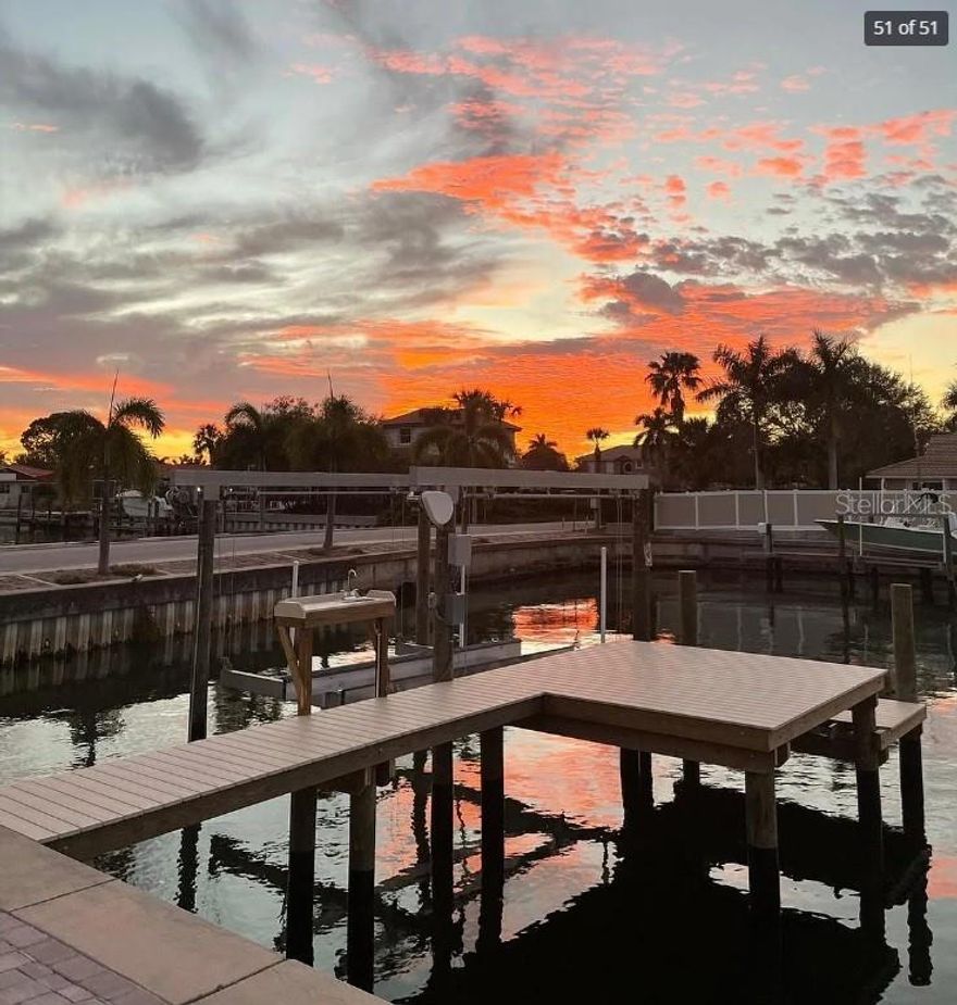 LOCATED IN THE HIGHLY SOUGHT AFTER COMMUNITY OF VENETIAN ISLES WITH RAPID BOATING ACCESS TO TAMPA BAY. This FULLY FURNISHED 4 bedroom, 3 bathroom, 2 car garage, 2,256 square foot home has loads of upgrades from a 2015 sea wall, 2008 tile roof, 2016 HVAC system, 2015 pool enclosure, fresh exterior paint, and the list goes on. 
Lush landscaping and a brick paver circular driveway welcome you home. The spacious kitchen boasts granite counter tops, stainless appliances, a breakfast bar, and spectacular water views. The living room offers surround sound (perfect for movie night), updated marble flooring, and sliding doors leading you to the pool area with a brick paver deck and screened enclosure. The large open formal dining room offers spectacular pool and water views through the glass sliders. The master suite provides ultimate privacy located at the south west corner of the home with sweeping water views and a walk in closet. The master bathroom boasts granite vanity counter tops, his/her bowl sinks, a separate glass panel shower, and a jacuzzi tub. From the master suite step out onto your tranquil pool patio and back yard to take in the views. Your 100+ feet of waterfront includes a dock with a boat lift and boat included (optional), lower tier that allows for easy kayak/water toy launching and a sitting bench.