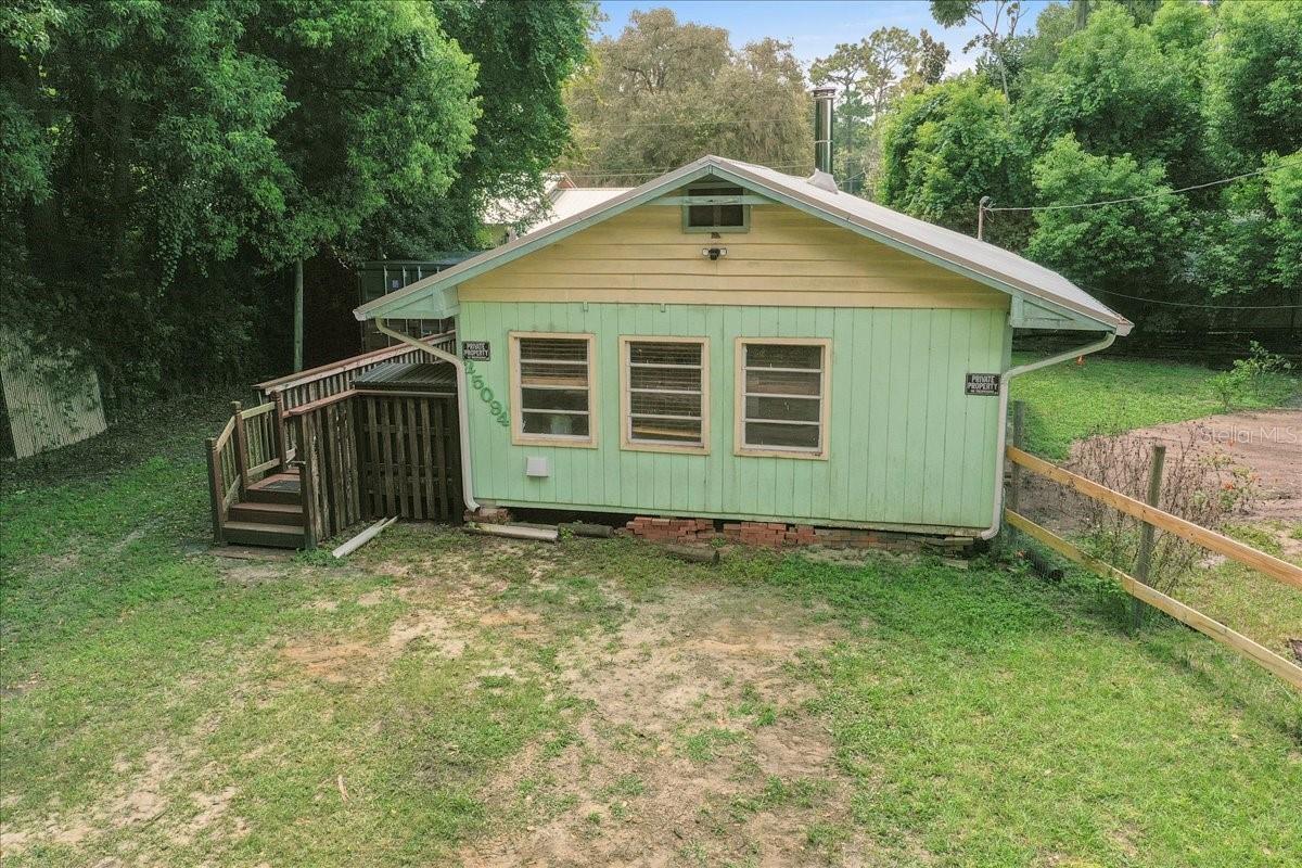 FANTASTIC OPPORTUNITY! Adorable little house nestled in the Ocala National Forest in the Kershores community located on Little Lake Kerr! This would make a great get away or an Air B & B investment! This home is just a few blocks from the Kershores community area with direct access to Little Lake Kerr. The home has a real "cabiny" feel, very cute and cozy. The kitchen and bathroom have been completely remodeled and all new flooring except in the bedroom which has a wood floor. The kitchen has a custom counter-top piece that fits over the sink when you need more counter space. A wood stove was installed for efficient heating and enjoyment, it is beautiful! The septic/drainfield was just replaced, the tankless water heater is newer, there is an iron filter for the well, the side deck was recently stained and the roof is a 3 year old metal. The yard is fenced and there is a Conex container for storage. Do not leave the area before going to the end of 247th Ct where the Kershores Community Area is located - for $100 per year, you have a boat ramp, a dock, a 3 acre beautiful grassy area with gorgeous trees and views of Little Lake Kerr. You can fish, swim from the sandy beach and picnic in the lighted picnic area, there is a clubhouse (currently being remodeled) which is available for parties, receptions and reunions. There are hundreds of miles of trails to walk or ride accessible from the community. Such a unique find!