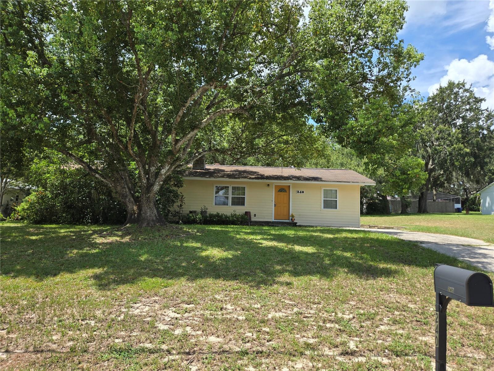 Nestled on a generous double lot in an established neighborhood is a little "diamond in the rough" home. This cottage is a perfect size for first time buyer(s) or seniors with 2 bedrooms, 1 bath and plenty of room to grow on almost half acre of land. Ample room for cars, boat or RV. There is NO HOA to worry about so, you can get creative too. The backyard has plenty of space and holds a detached, oversized barn/garage with workshop and huge attic! The barn has so much potential and is already loaded with electrical outlets, work benches, lighting and more. A must-see area.
Back inside the quaint cottage you'll find original hard wood floors and a unique stone fireplace. It's an open Livingroom plan with a galley style kitchen. The kitchen has been renovated and has plenty of nice cabinets for your things. All appliances are ready for your use. Through the hallway to the large primary bedroom with lots of windows and a walk-in closet. The secondary bedroom also has a walk-in closet. Bathroom is light and bright with a shower/tub combo and a few built-in shelves for toiletries and towels. The house needs a little TLC but it is livable, and you can make it your own style.
Conveniently located near shopping, restaurants, schools and Groveland's Lake David Park. In fact, it's just a couple of blocks to Lake David Park, where you'll find all kinds of amenities and activities including: a public boat ramp, dock, fishing, barbecue grills, basketball and volleyball courts, 2 picnic pavilions, picnic tables, large playground, and a skate park. Additionally, Groveland’s new splash pad is a fantastic spot to cool off. The park also hosts the popular Second Friday events, offering live music, food vendors, and a fun community atmosphere. Holidays are even more fun here! Come enjoy the lifestyle in Groveland.