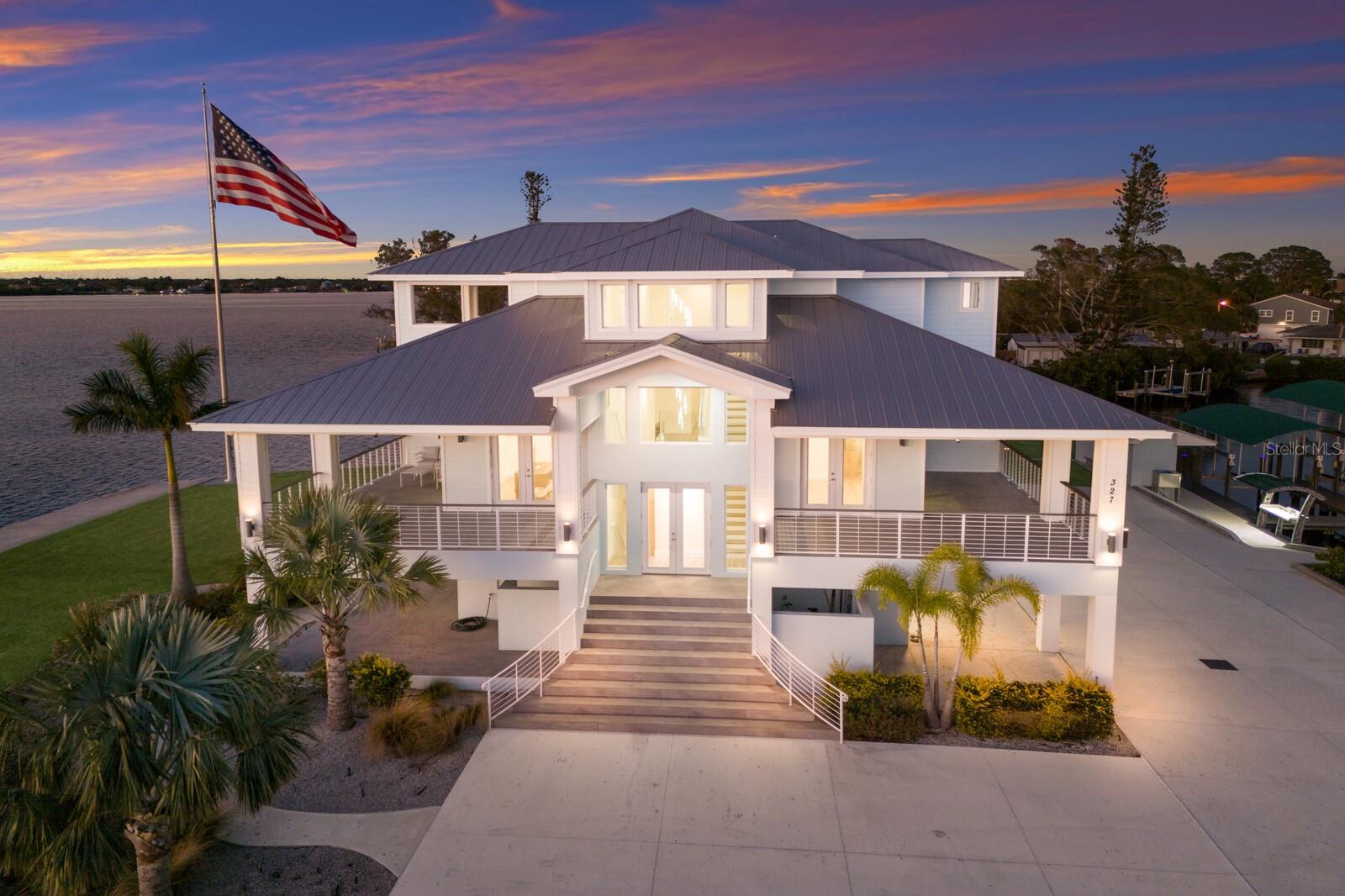 PARADISE POINT...A WATERFRONT MASTERPIECE ON THE MANATEE RIVER!!! Nestled on a PRIVATE 2.20 ACRE PENINSULA , Paradise Point is a breathtaking waterfront GATED ESTATE offering unmatched LUXURY and DIRECT ACCESS to the Manatee River, Tampa Bay and the Gulf. This 2023 custom built Key West style home boasts over 670 feet of water frontage, providing panoramic views of the Manatee River. YOU WILL NOT FIND A BETTER VALUE FOR A NEW WATERFRONT HOME ON ACREAGE!!! Imagine absolutely stunning sunrises followed by even more beautiful sunsets in the evening, all while sitting on your multiple covered lanais on each level of the house! Truly a Home of Luxury & Comfort. Spanning nearly 6,000 square feet of air-conditioned space , with a total of over 12,800 square feet including porches and garage space, this home is designed for both relaxation and grand entertaining. The open-concept living area showcases expansive water views out of almost every room. As soon as you enter the main living area you will notice the high ceilings and natural light streaming in thru all the windows in the great room. The gourmet kitchen is a chef’s dream, featuring Wolf and Thermador appliances, gorgeous shaker style cabinetry, dual dishwashers, and a huge island that is the perfect spot for hosting gatherings. Take the stairs or elevator to the private third-floor owner’s suite. Truly a serene retreat, complete with a spacious lanai with cypress ceilings, two oversized walk-in closets, and a spa like bathroom featuring a Jacuzzi soaking tub and a 12’x8’ Thermosol wet sauna steam shower. The main level offers four additional bedrooms, including one ideal for a home office. A 15-person theater room on the first floor elevates the home’s entertainment experience. The 6 car garage is huge and offers endless possibilities for the car enthusiasts or just for those looking for storage. Built for absolute strength, this home was constructed way beyond standard building codes! This estate is engineered for maximum durability and energy efficiency. With a completely solid block structure, reinforced concrete floors, a fire sprinkler system, and state-of-the-art roofing material with polyurethane insulation, it provides superior storm resistance. Its high elevation has ensured it remains completely dry through past hurricanes, offering unparalleled security and peace of mind! The exterior is truly an outdoor paradise for boating & entertaining! Designed for those who love the water, this estate features plenty of dock space along a protected deepwater lagoon. You can tell that this area was designed by someone with lots of experience on the water and that they constructed this area with an open check book! Featuring trex decking, built in dock lighting and two private covered boat slips—one with a 16,000 lb lift and the other with a 10,000 lb lift—as well as a concrete shed to store all your boating/fishing gear and your ice machine! Additionally there is a fish cleaning station and shore power at the dock. Truly a dream set up!! Conveniently located just minutes from downtown Bradenton, this estate is near top-tier schools, including IMG ACADEMY, ST STEPHENS AND BRADENTON CHRISTIAN SCHOOL! Only minutes to the Gulf Beaches of Anna Maria Island, short distance to downtown St. Pete and the cultural & culinary arts of Sarasota. TRULY AN AMAZING LOCATION WITH EASY ACCESS TO SO MANY OPTIONS!